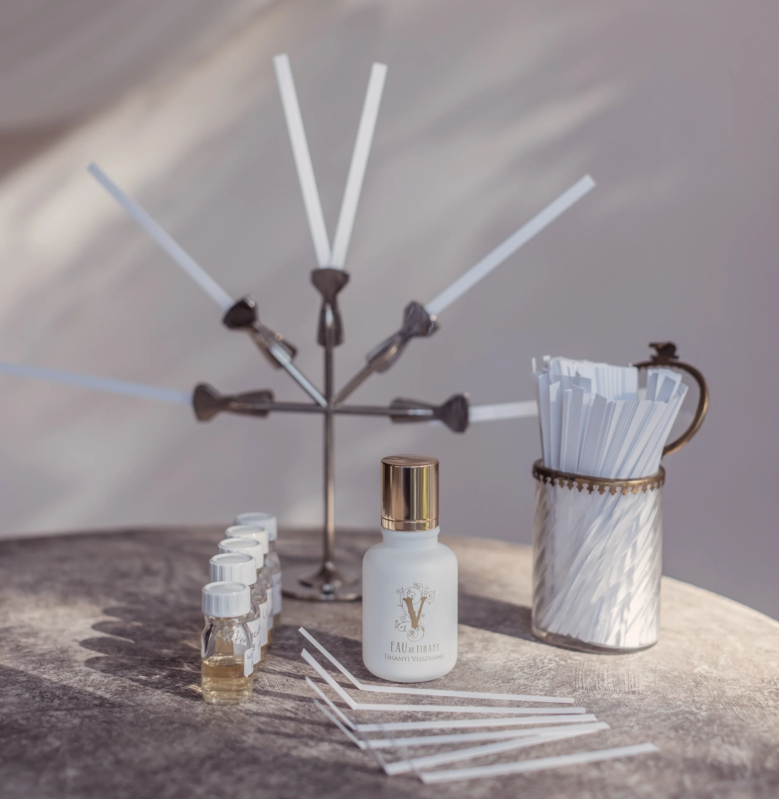 Strategic olfactory branding tools: perfume formulation vials and professional scent strips for corporate signature fragrance design.