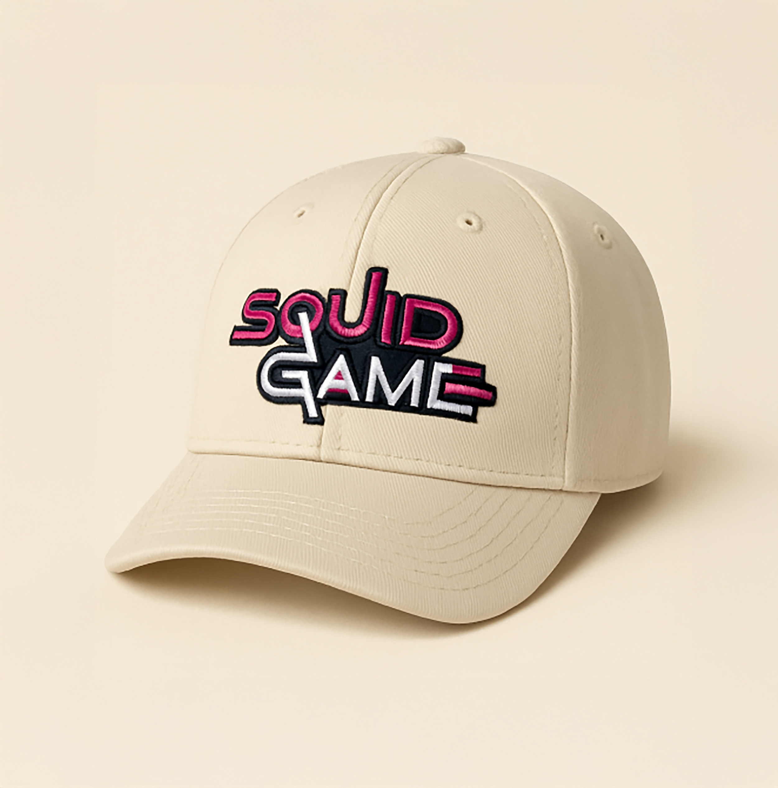 A cream-colored baseball cap with embroidered text that reads 'SQUID GAME' in pink, white, and black colors.