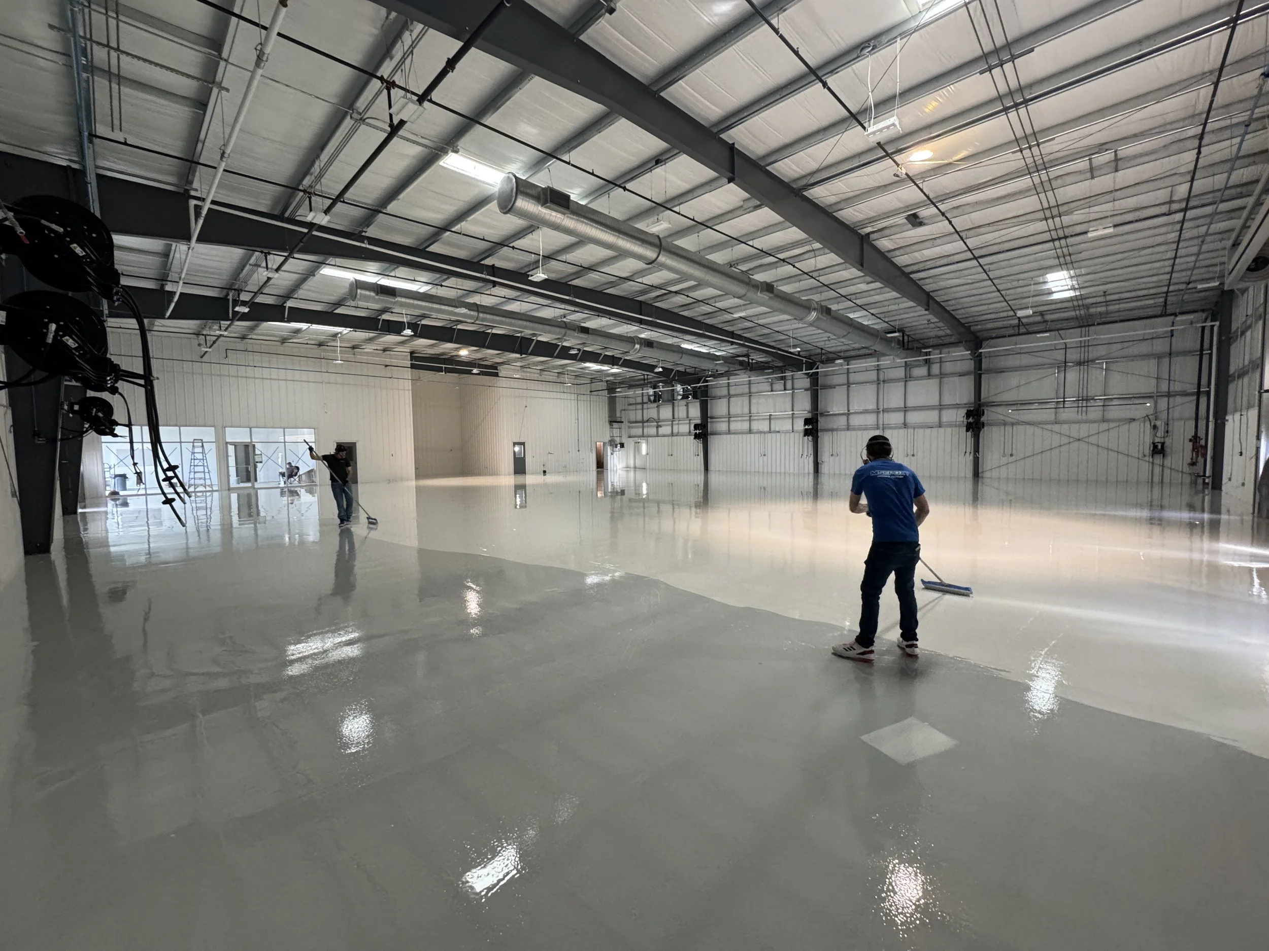 Installation of solid color epoxy flooring in automotive shop Glucksdat MS
