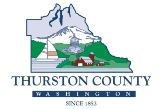 Illustration of Thurston County, Washington, featuring mountains, a river, a yacht, a capitol building, and houses, with the text 'Thurston County Washington Since 1852'.