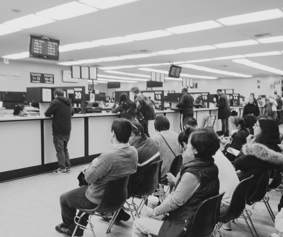 Individuals being assisted at a public counter in a municipal office, showcasing professional janitorial services that support clean and hygienic civic environments.