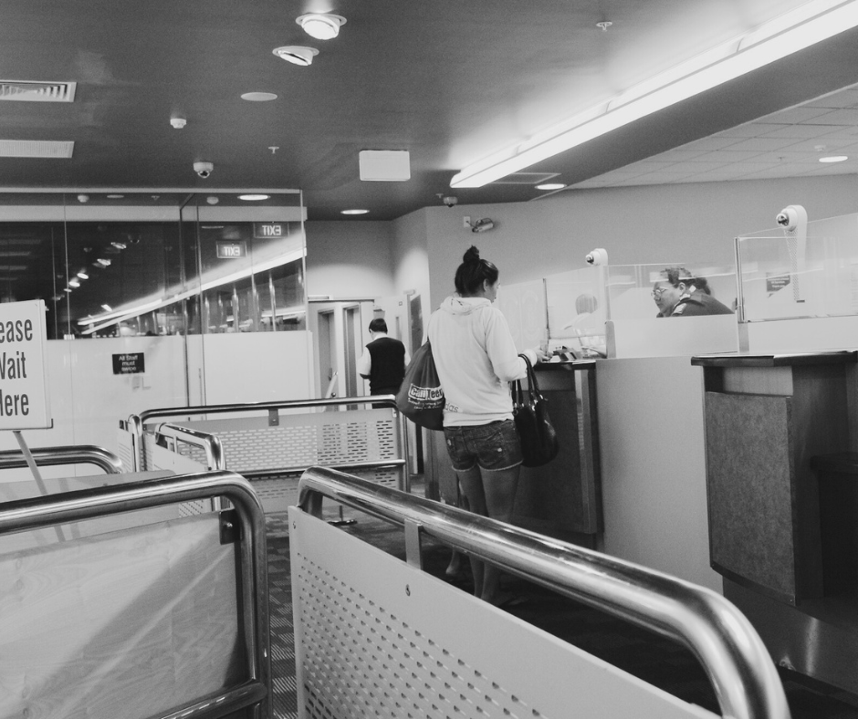 People being assisted at public service counters inside a municipal office, illustrating commercial cleaning services that support organized, hygienic workplaces in government buildings.