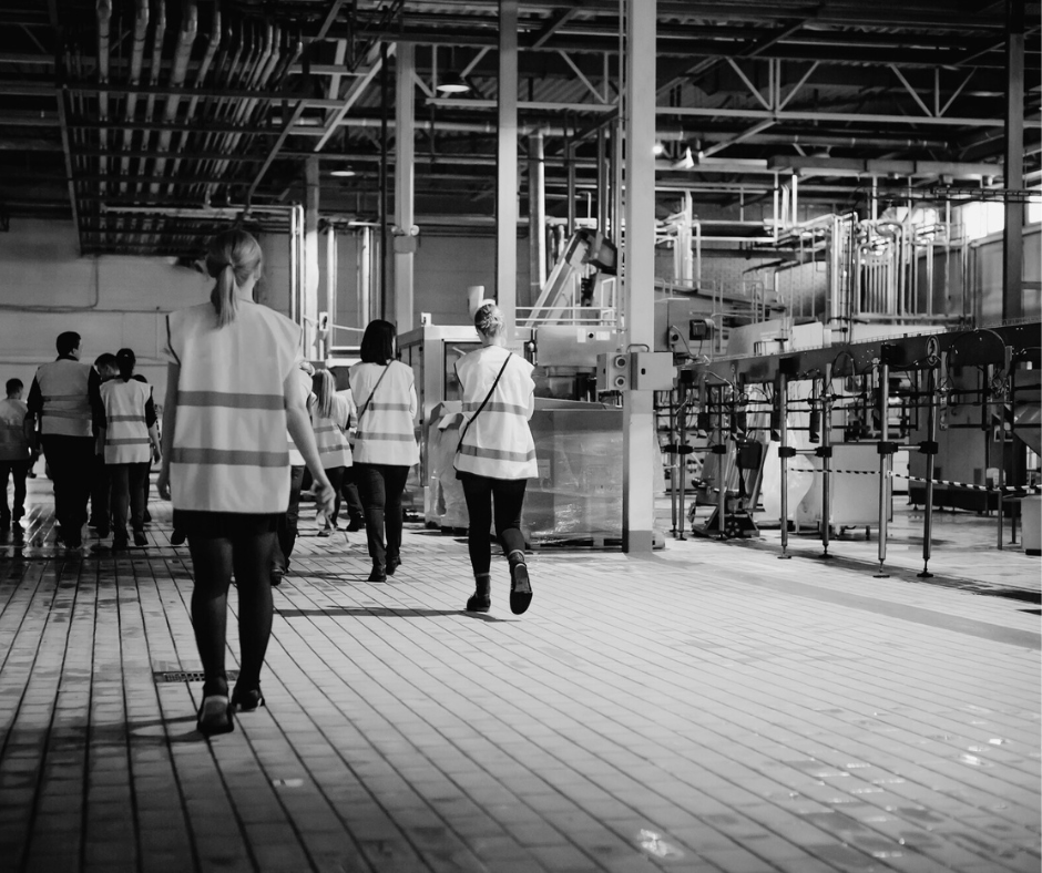 Commercial cleaning staff moving through an industrial facility where professional janitorial services support safety, maintenance, and compliance.