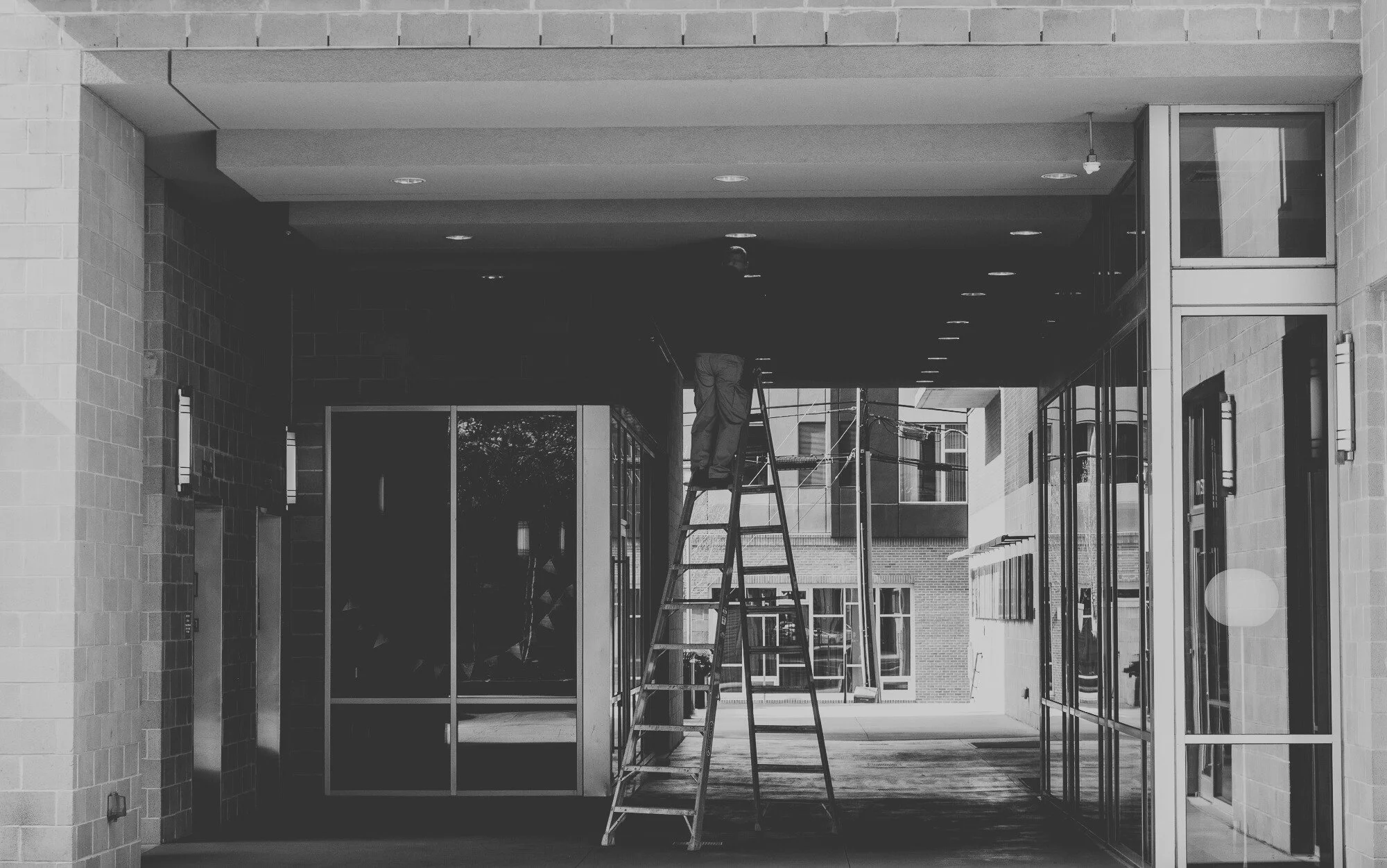 Exterior lighting maintenance being performed to improve safety, visibility, and energy efficiency