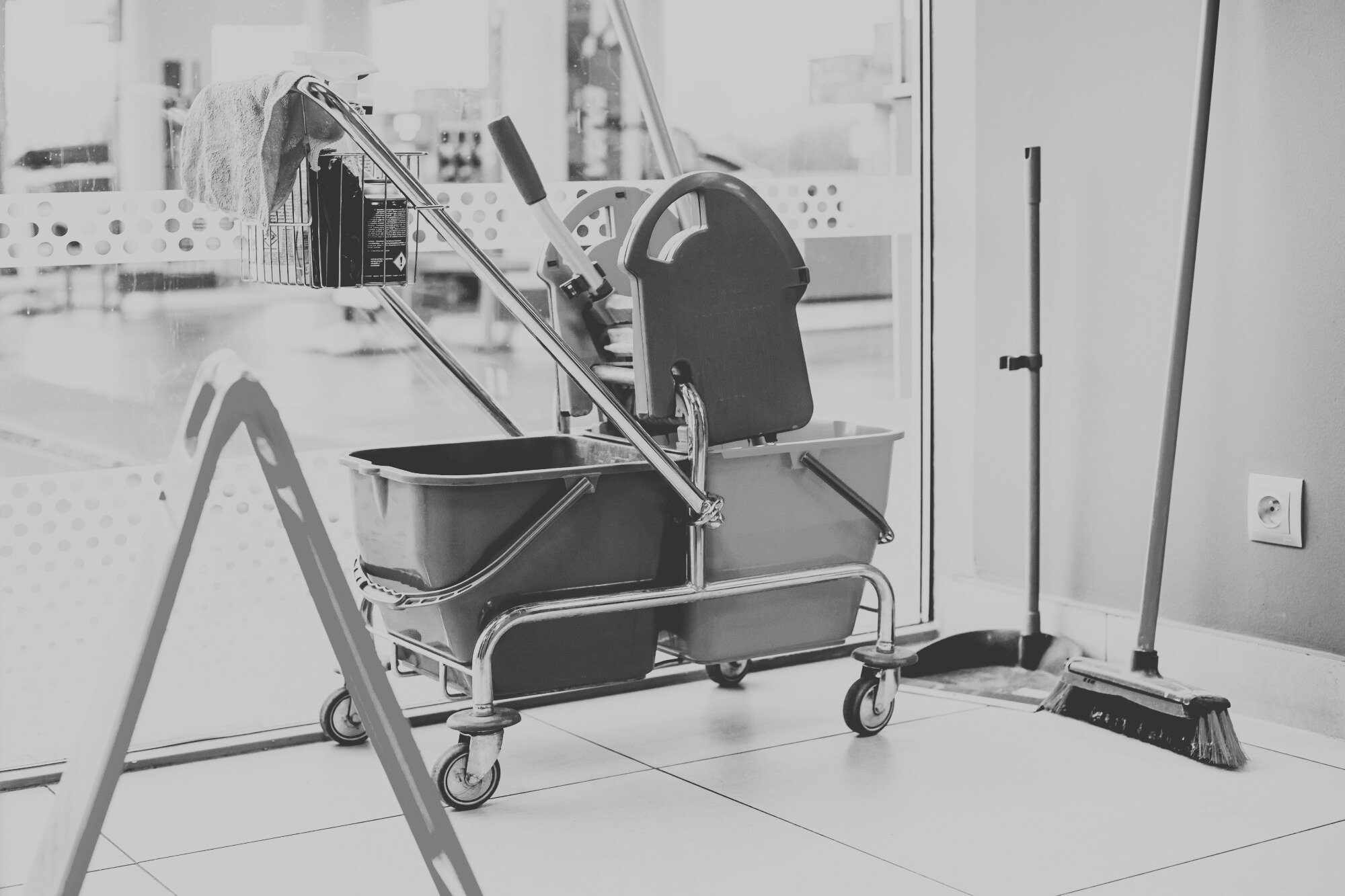 Janitorial cleaning company supply cart with commercial cleaning equipment prepared for seasonal transition services