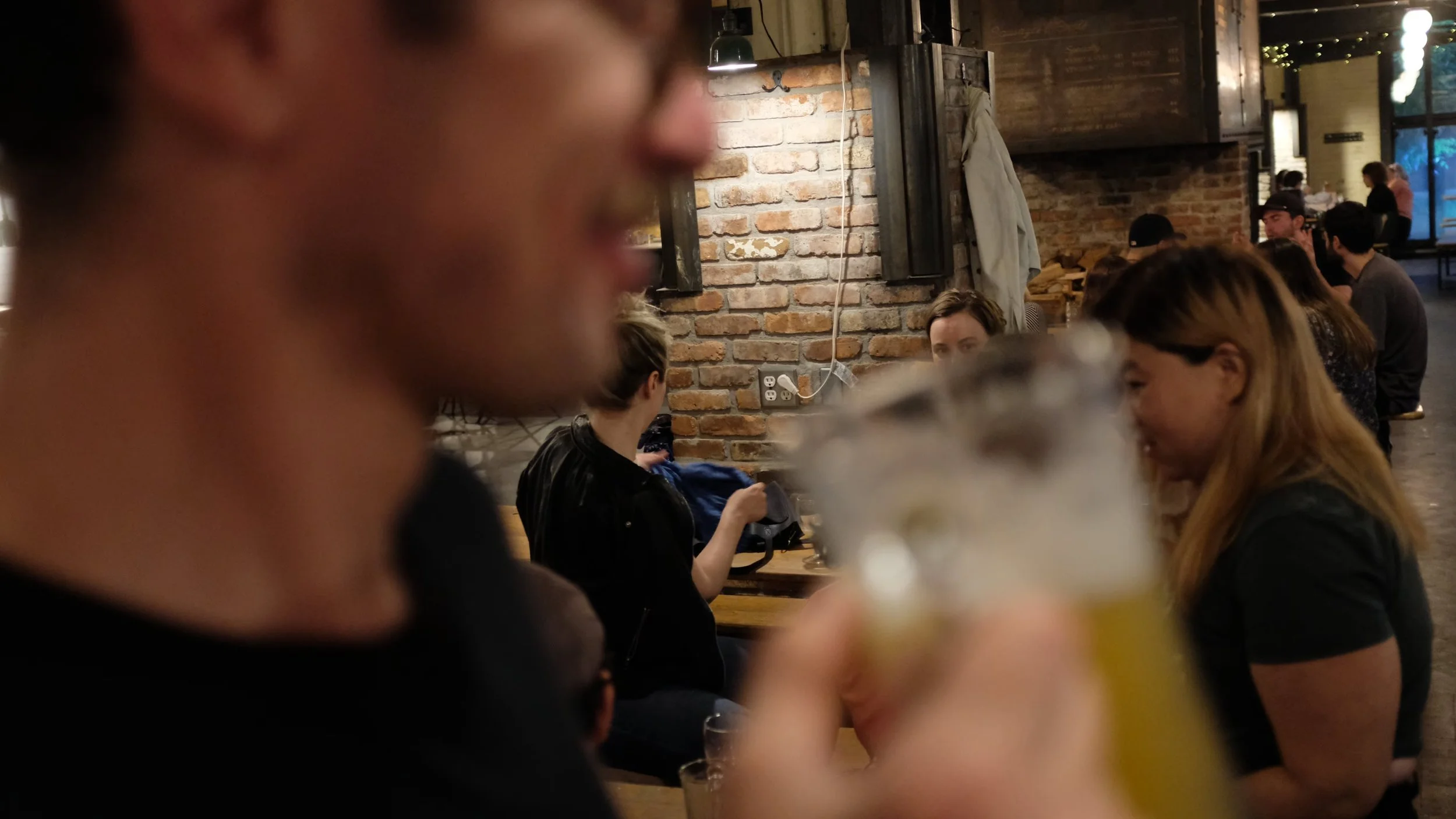 Image of a person drinking in a bar at a social meetup of cyclists