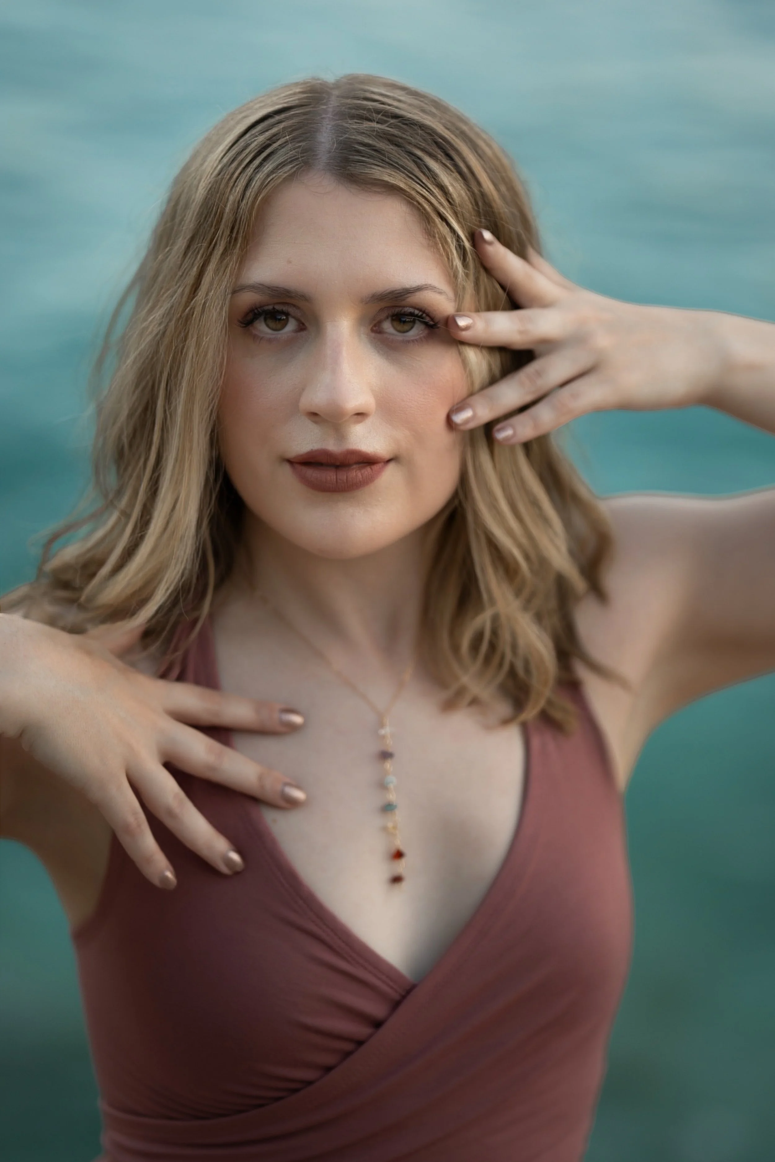 Lacey holds her hands on her chest and face