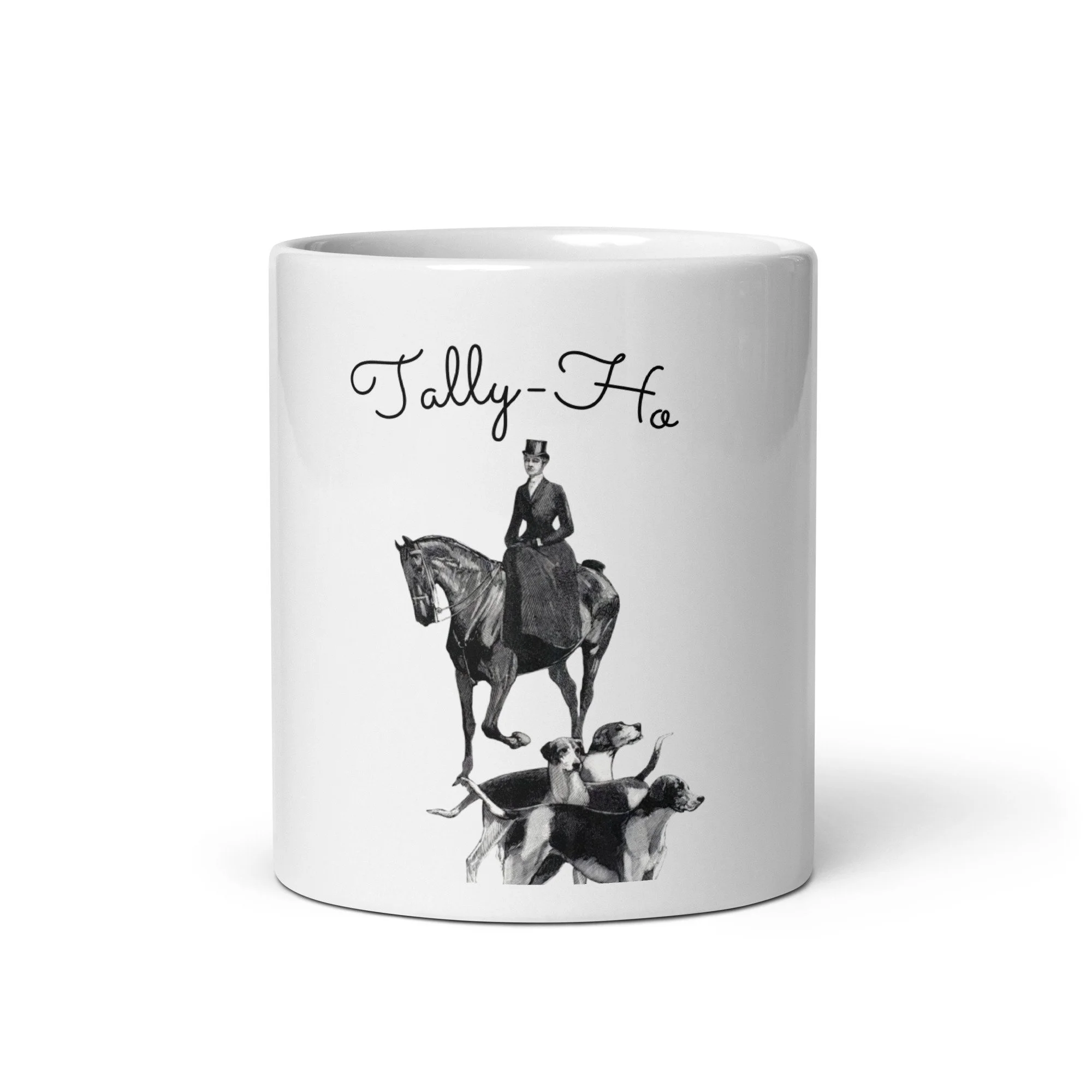 A white mug with a vintage illustration of a woman riding a horse and three dogs, along with the text "Tally-Ho" in a cursive font.