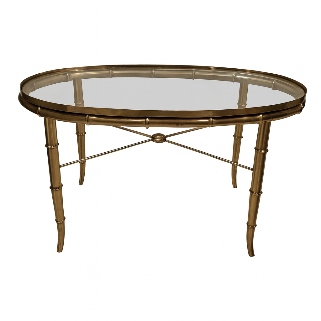 A round coffee table with a glass top and a bamboo-style metal frame.