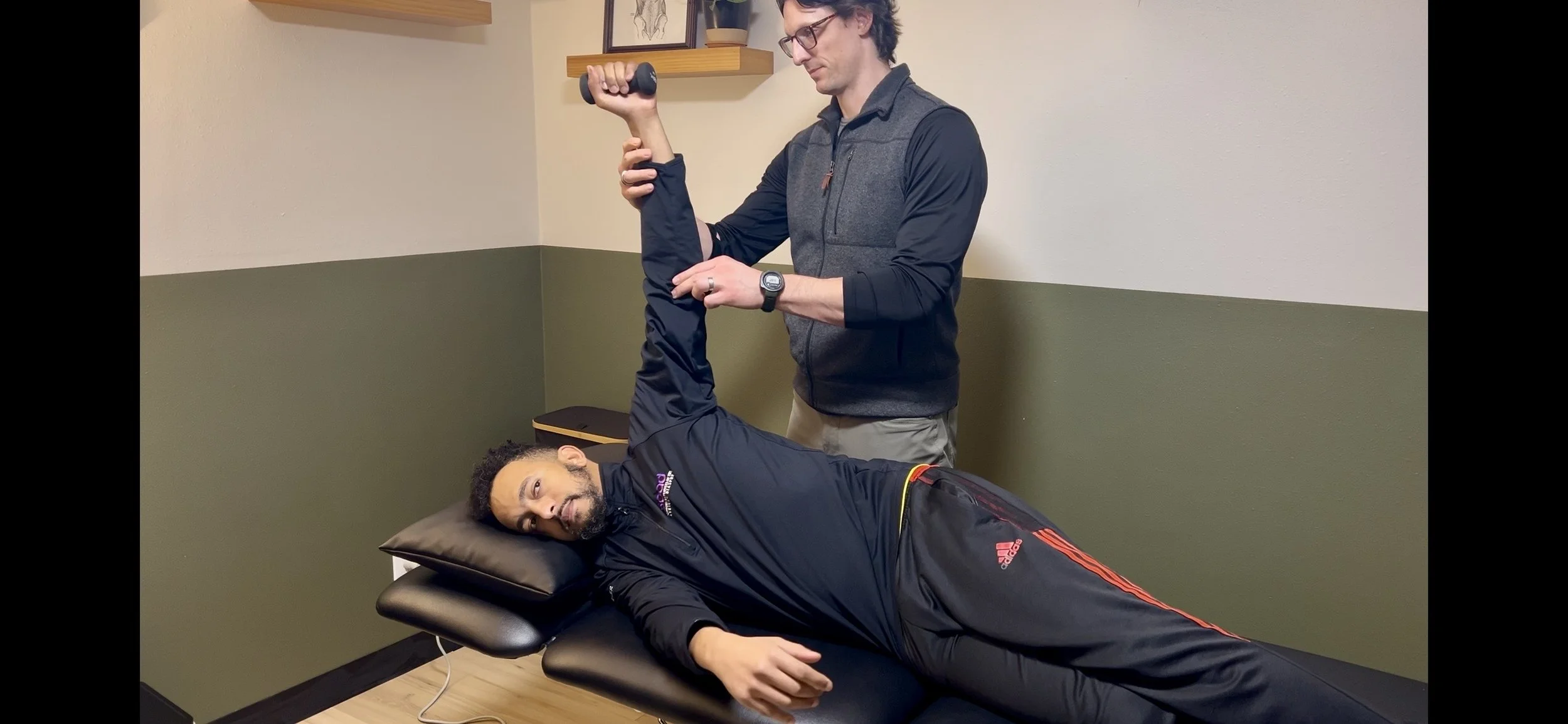 Dr. Ryan Eckert supporting a patient performing an arm bar.