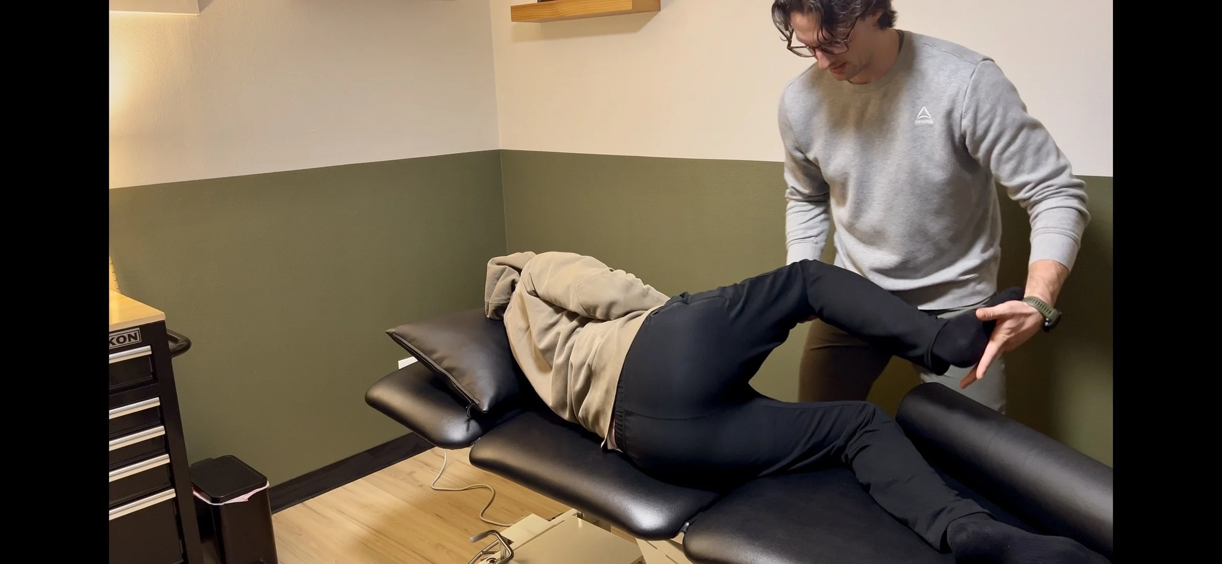 Dr. Ryan Eckert performing hip flexion in sidelying