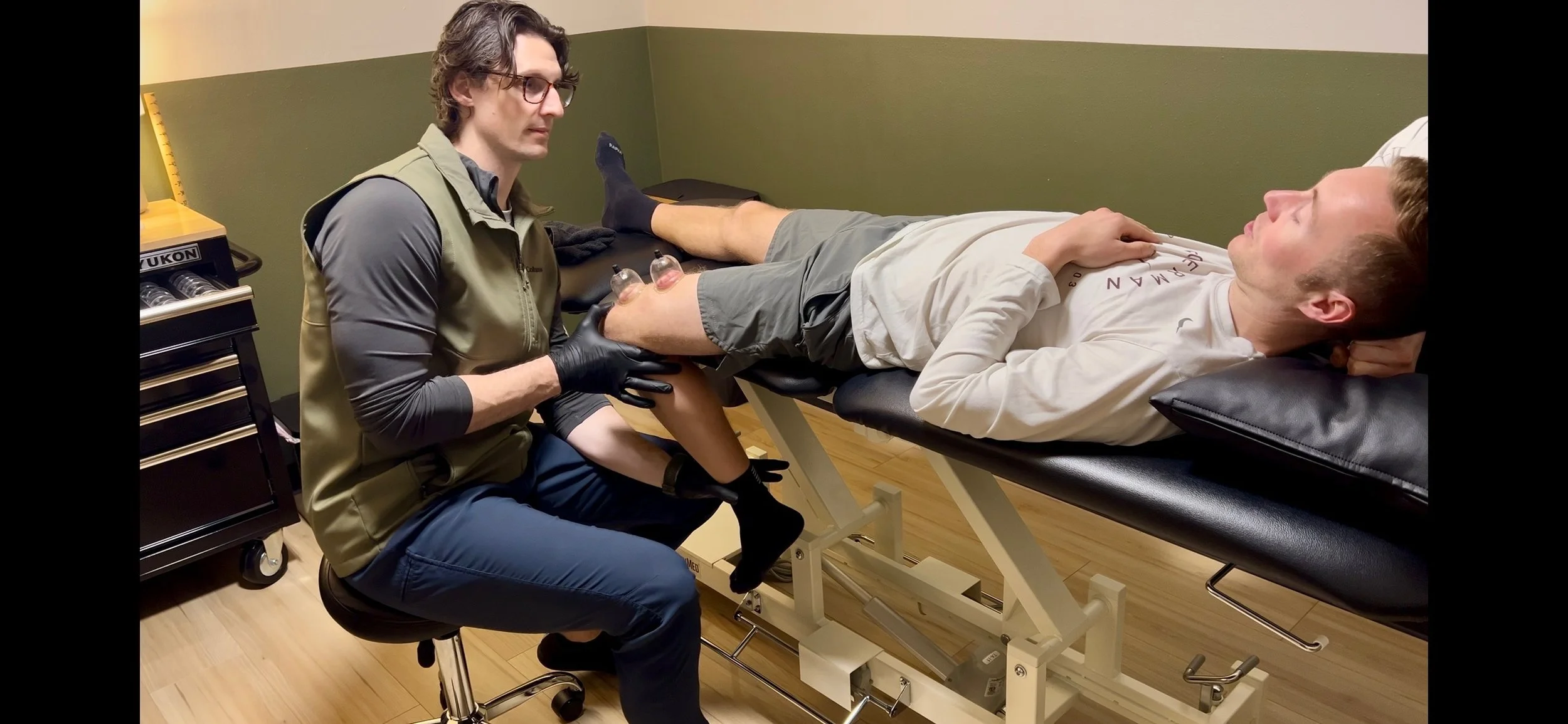 Dr. Ryan Eckert performing myofascial decompression to patient with knee pain