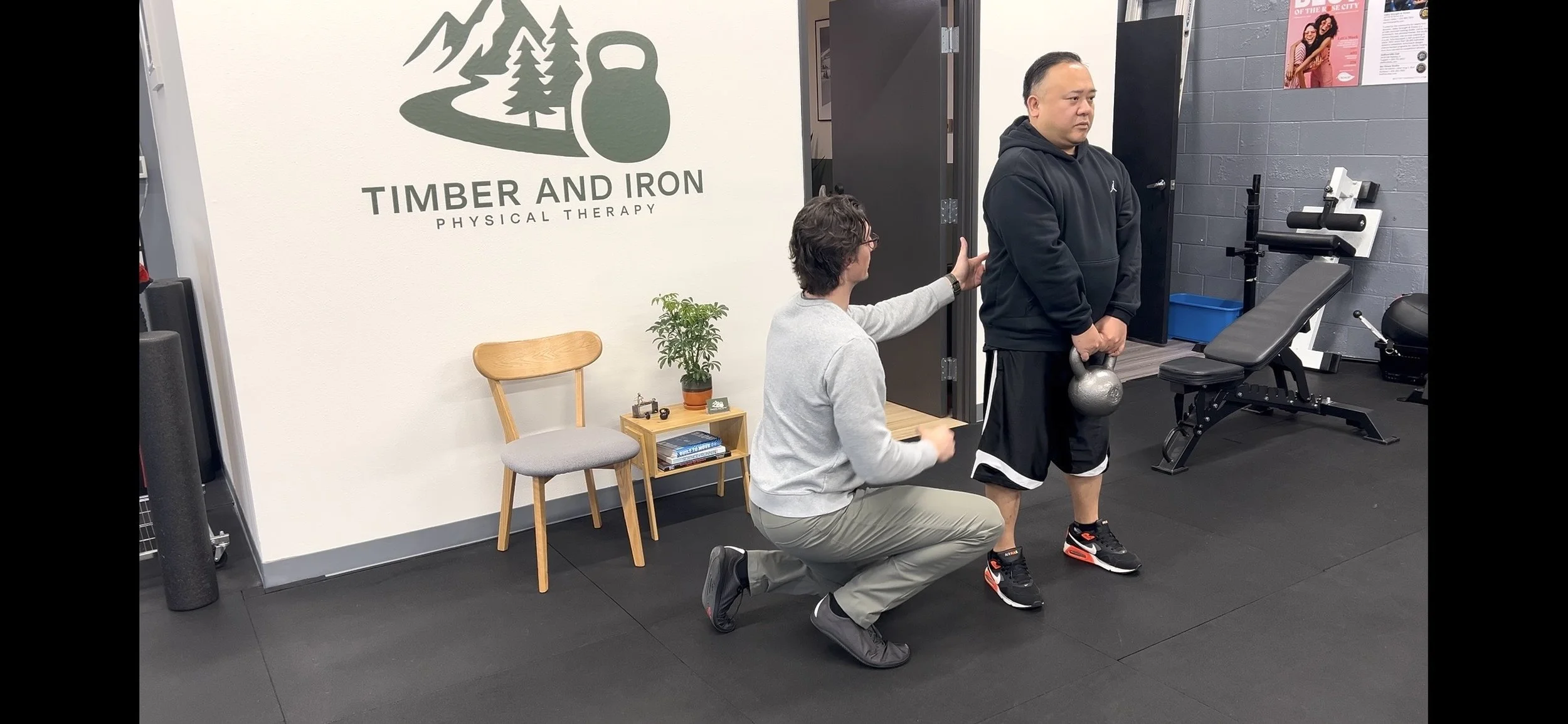 Patient performing a KB deadlift with Dr. Ryan Eckert to help with his form in recovery from low back and hip pain.