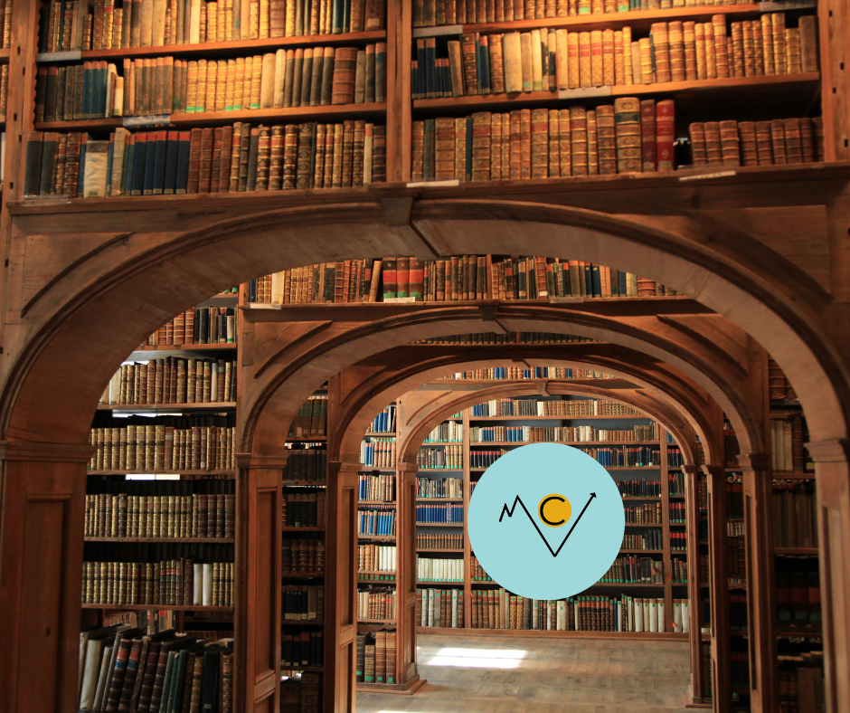 Interior of a large, wooden, multi-leveled library with shelves full of old books, viewed through arches.