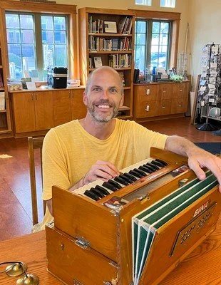 man playing harmonium monk in Connecticut