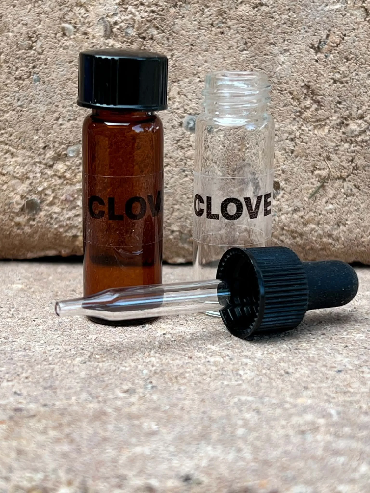 Amber glass oil bottle with a glass dropper and clear storage bottle for scent work and nose work essential oils.