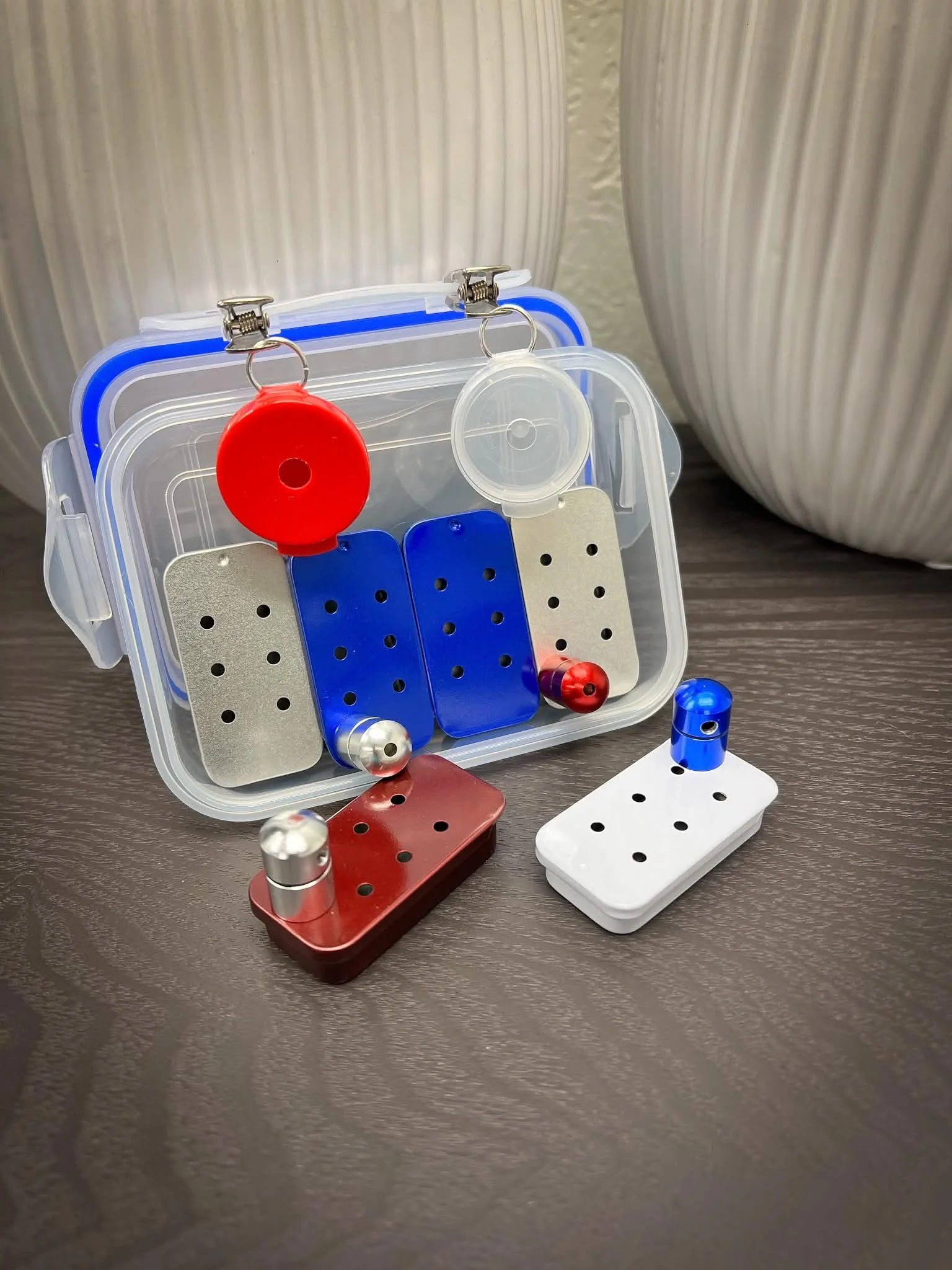 Compact scent work and nose work kit with a variety of training vessels and hides.