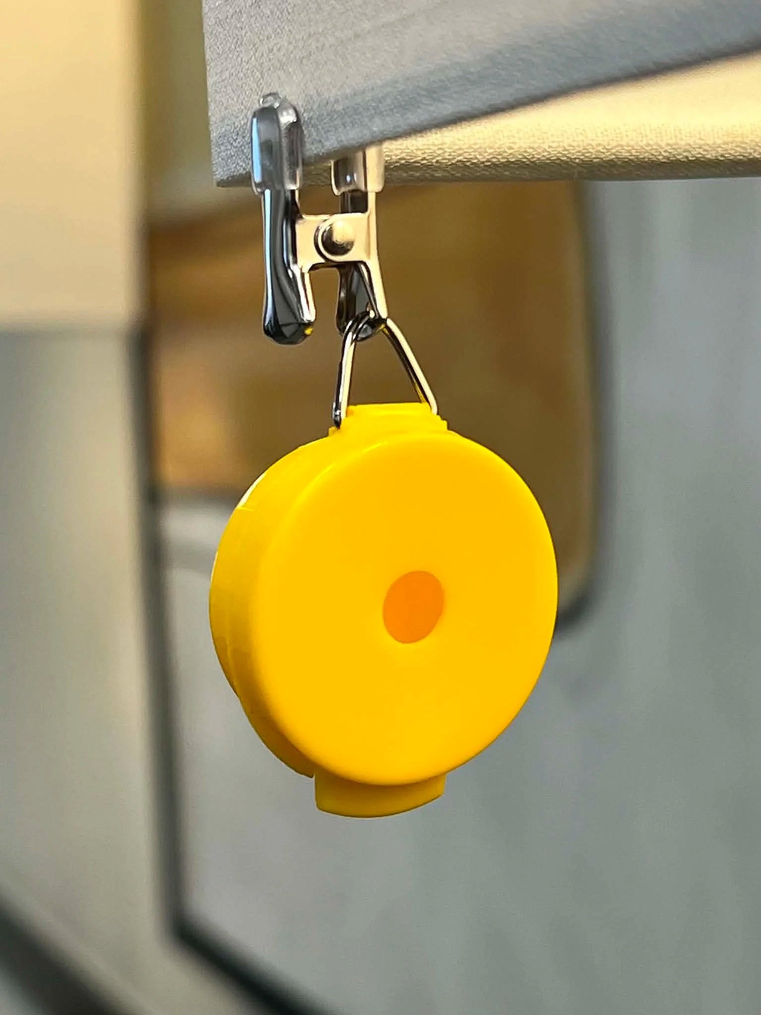 Yellow hanging nose work vessel attached to a tree branch during outdoor training