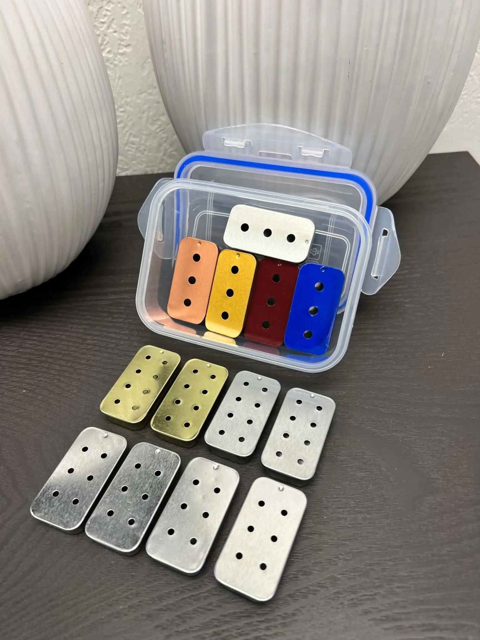 Variety of slider tins for nose work, scent detection, and canine odor training practice.