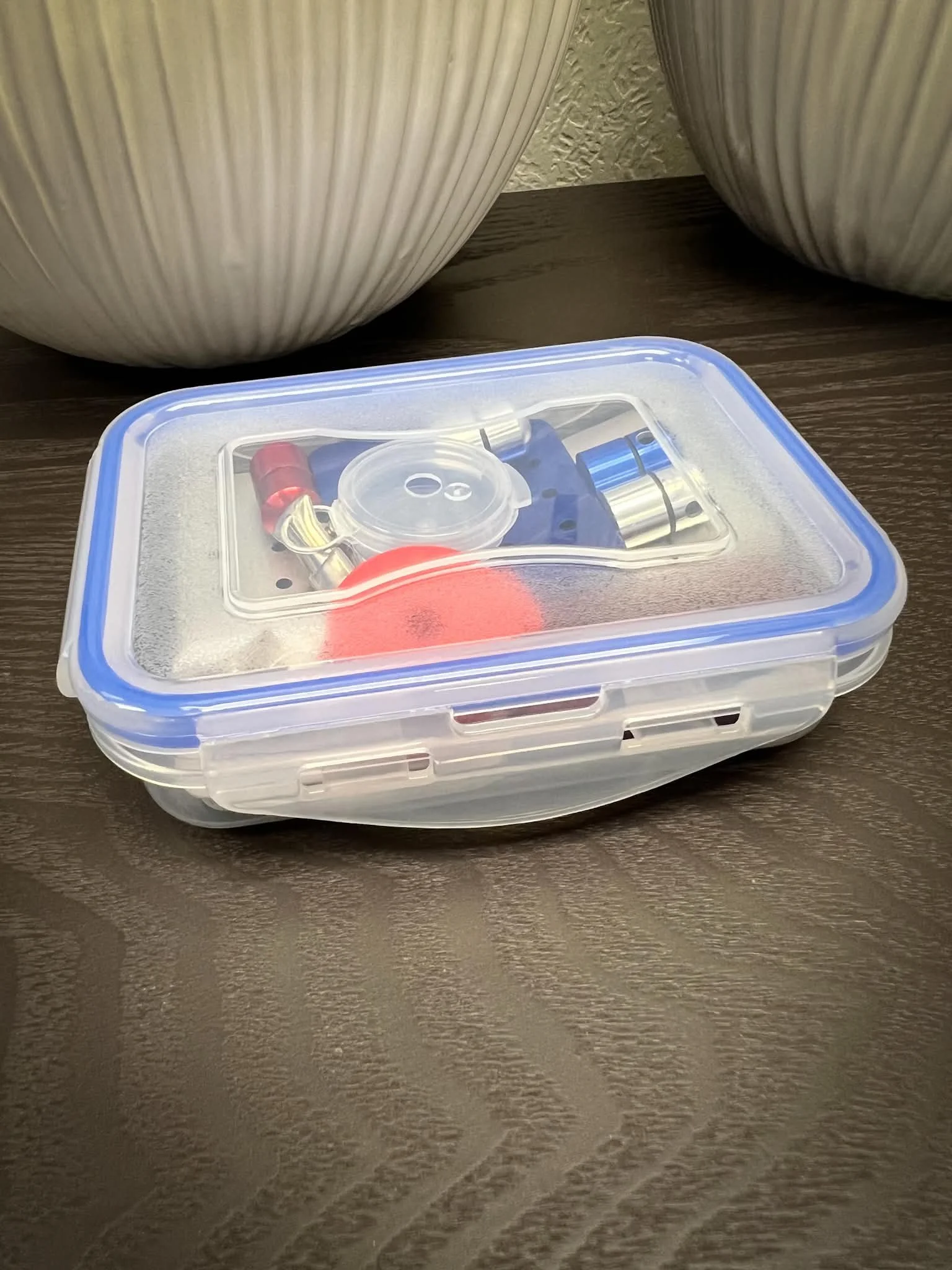 Compact scent work and nose work kit with a variety of training vessels and hides.