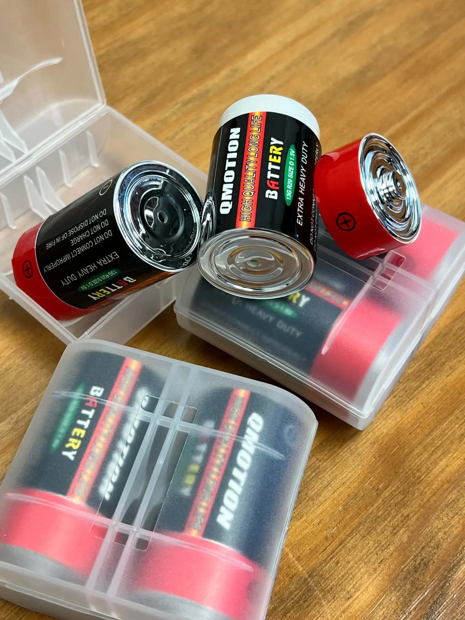 Realistic D battery hide vessels blended into a battery storage bin for hide-in-plain-sight scent work training.