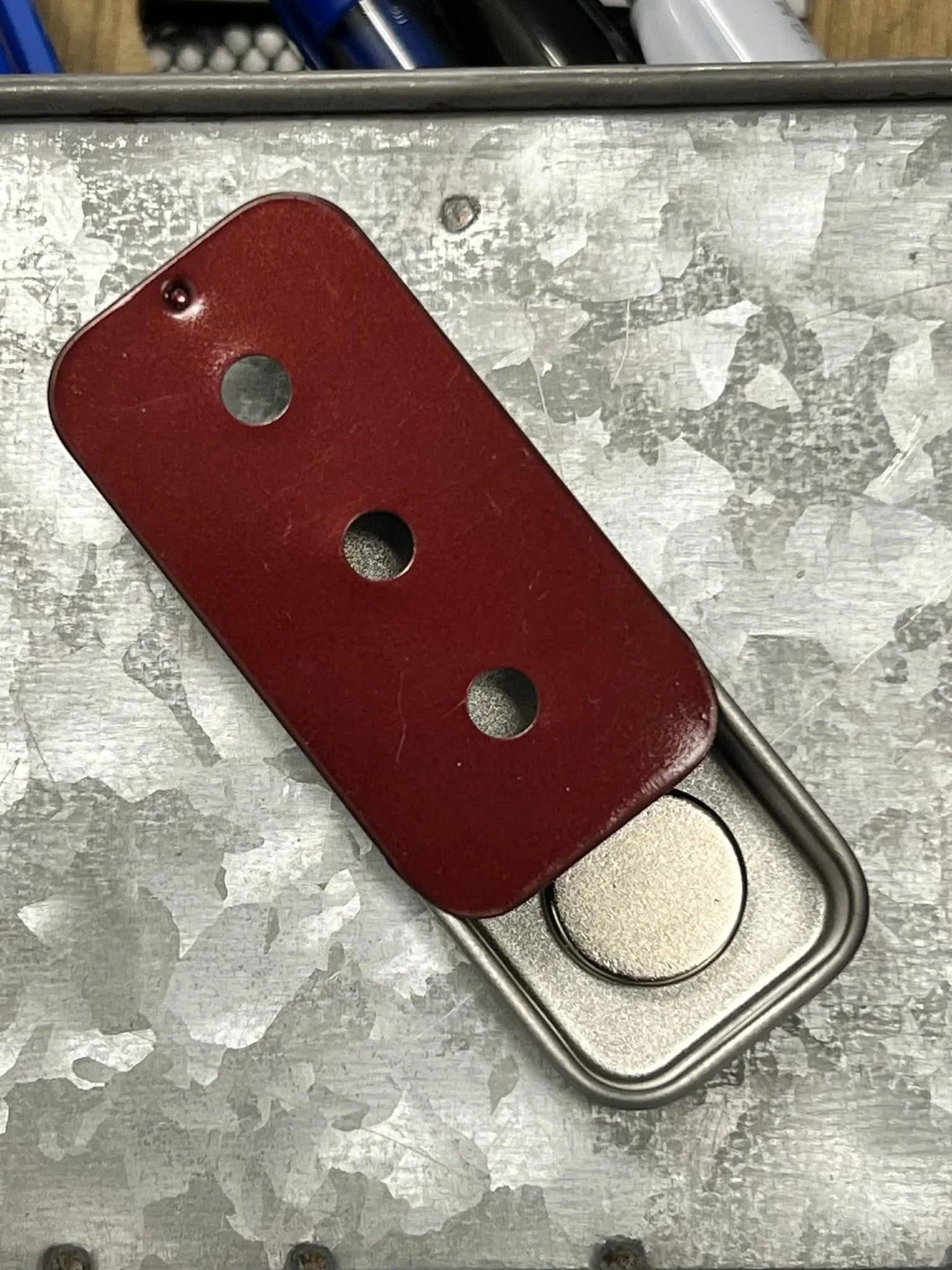 Red magnetic slider tin with three holes for UKC scent work