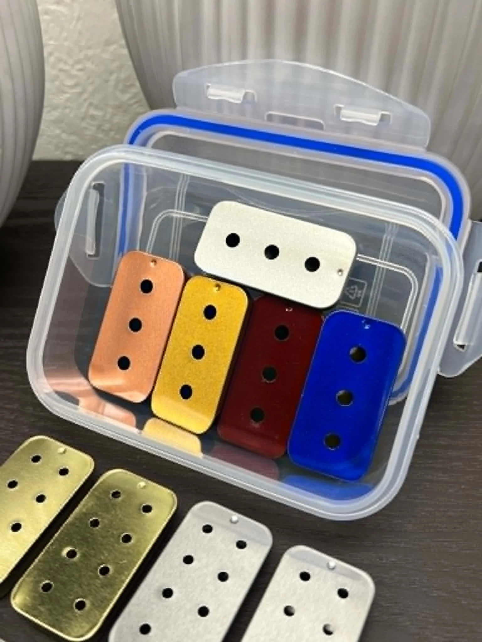 Scent work training slider tins assortment including three-hole, six-hole, and eight-hole tins