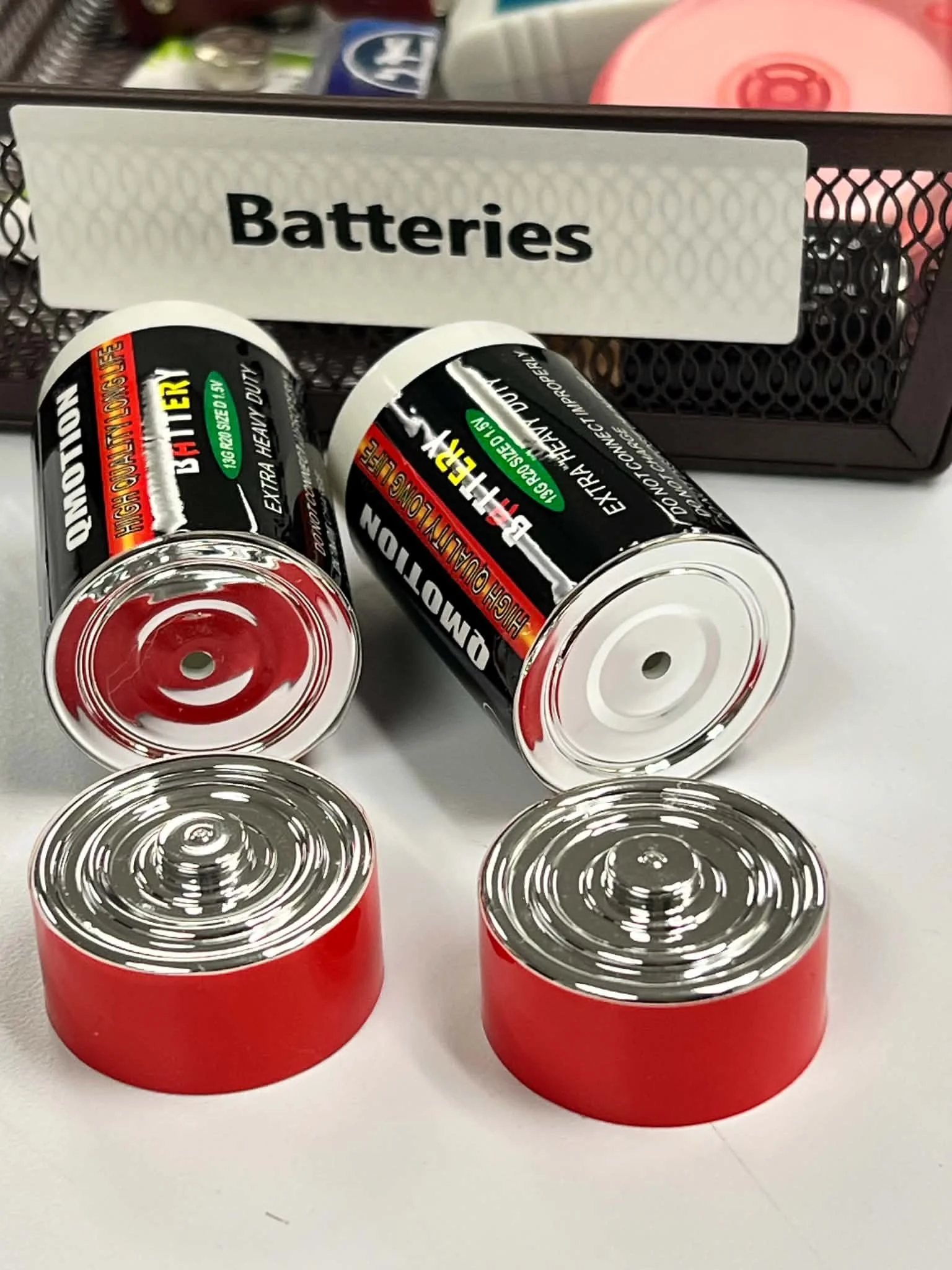 Realistic battery hide vessel placed among everyday supplies for challenging hide-in-plain-sight scent work scenarios.