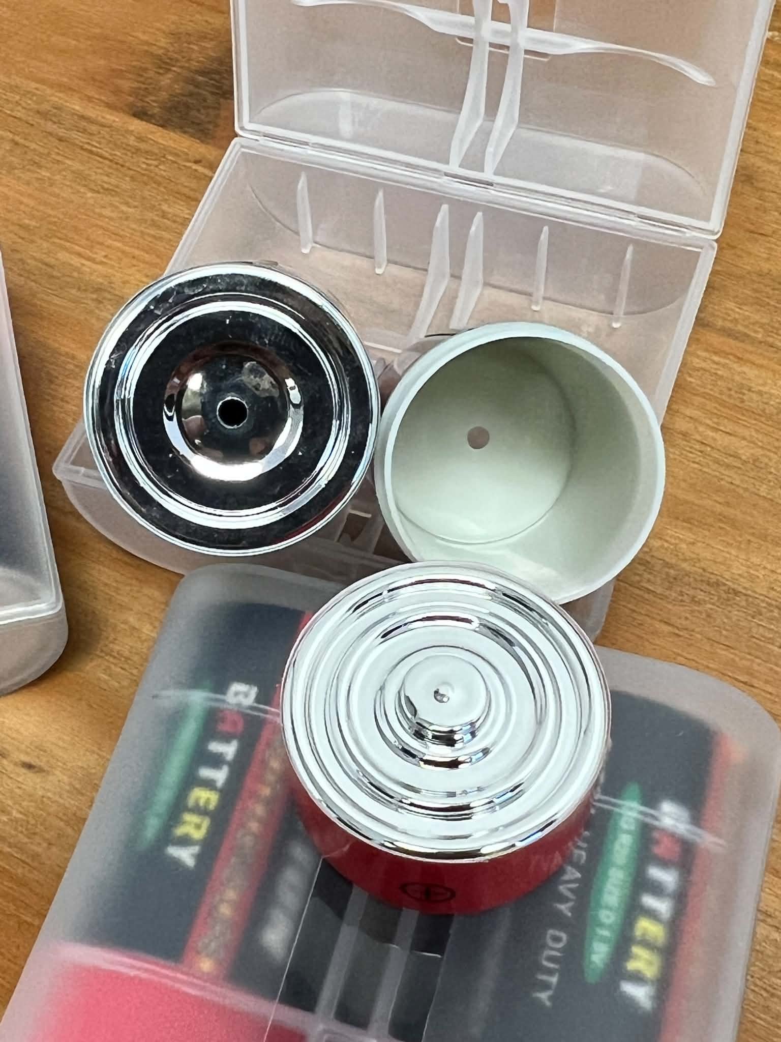 Two realistic D battery scent work hide vessels with storage case for creative nose work training exercises.