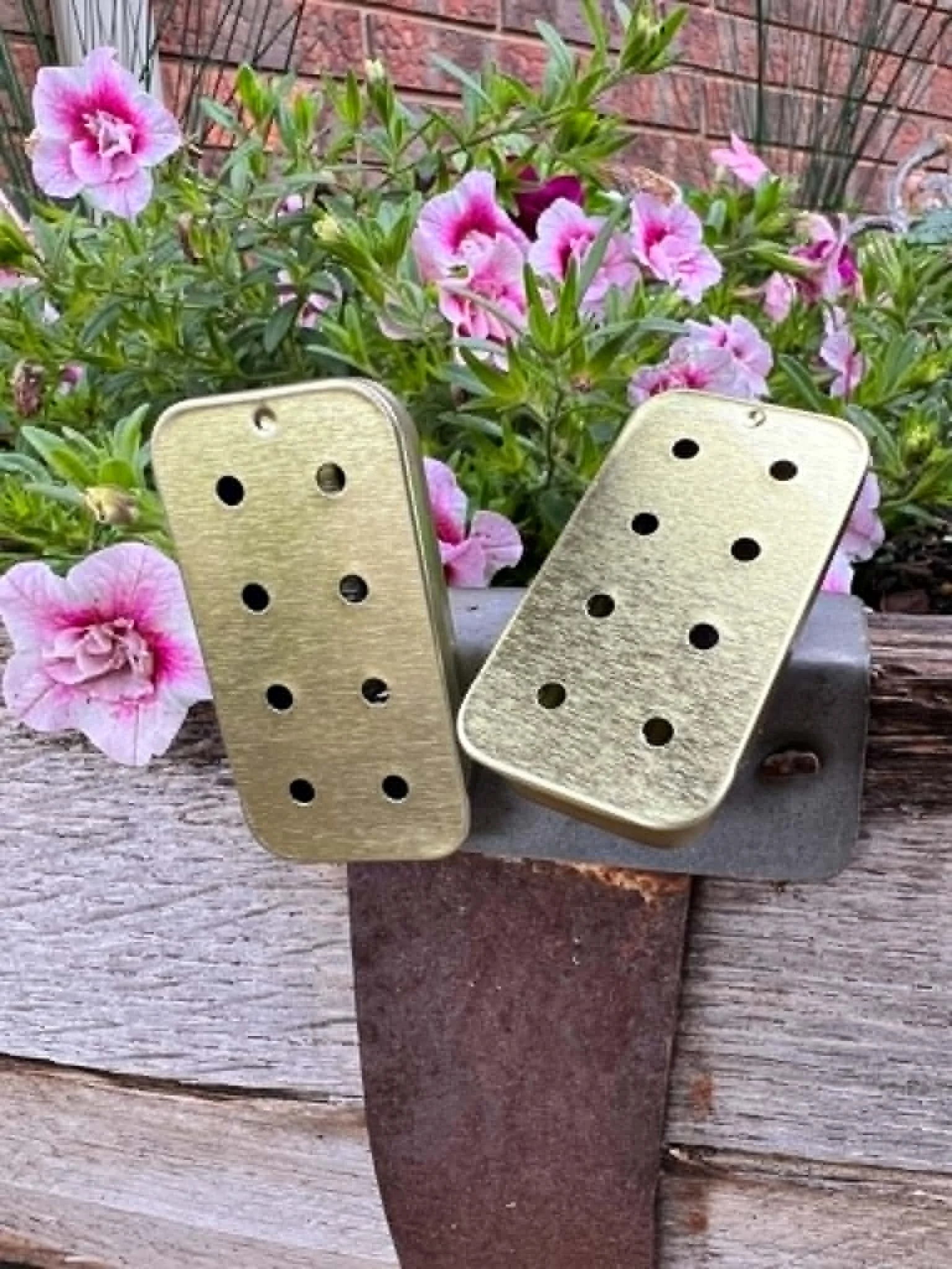 Close-up of a gold 8-hole slider tin used as a scent work vessel.