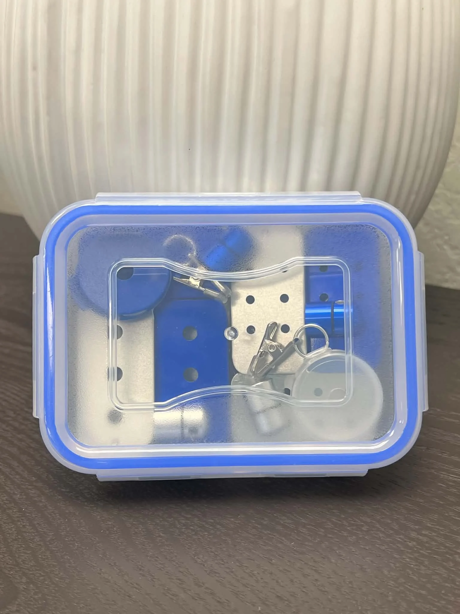 Compact blue and silver scent work kit in clear latch-top storage case for dog nose work training