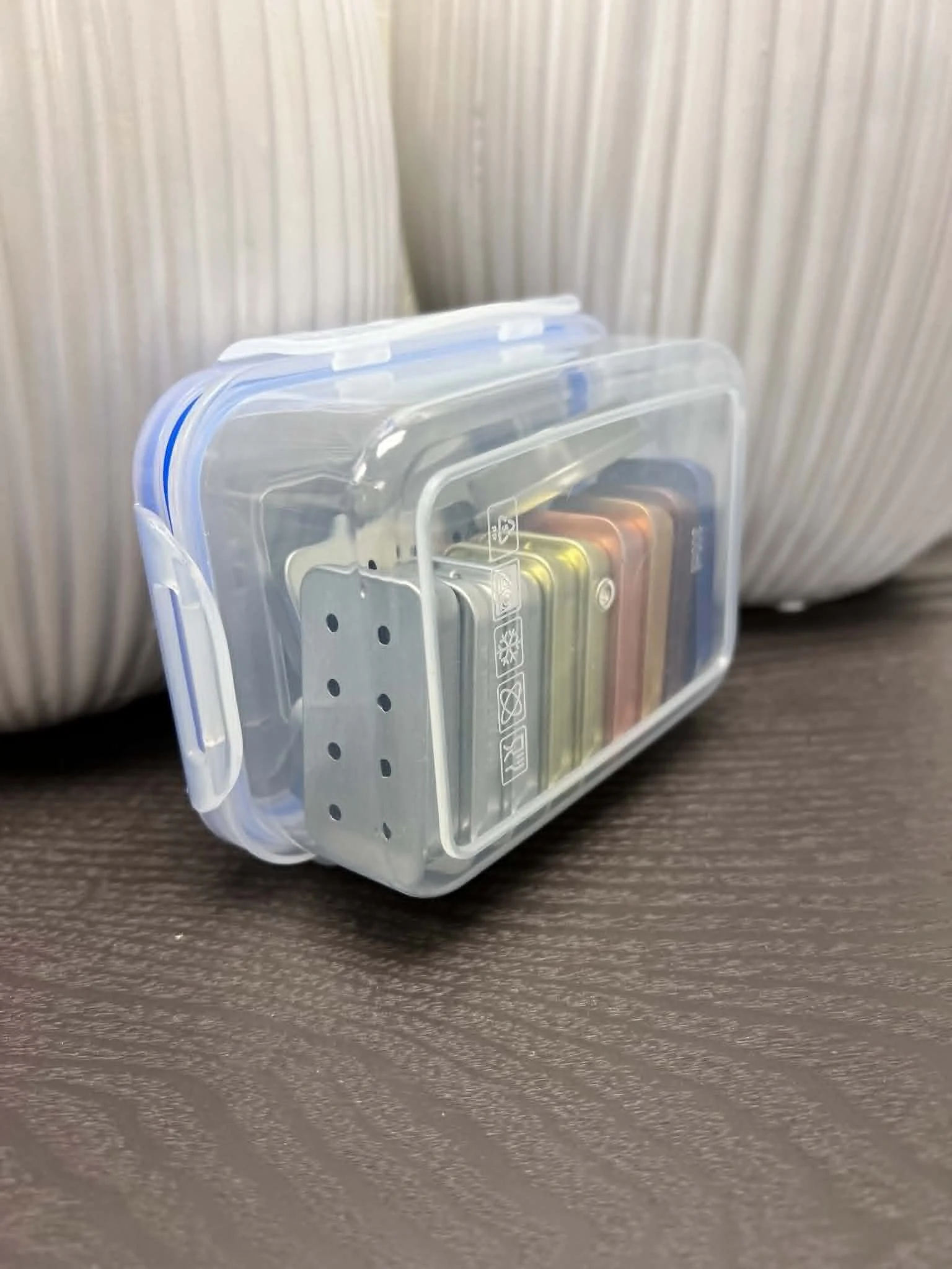 Reusable locking storage box filled with scent work slider tins for odor training and hide searches.