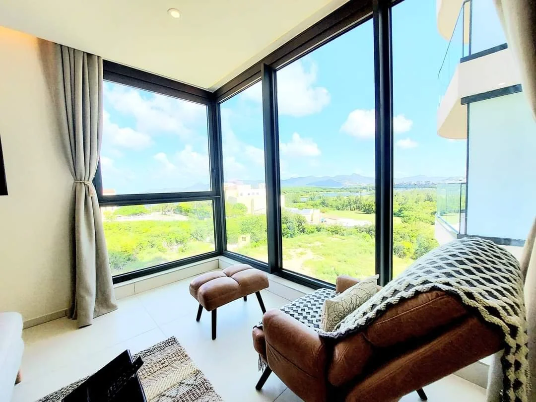 view from the living area overlooking the golf course, lagoon and mountains