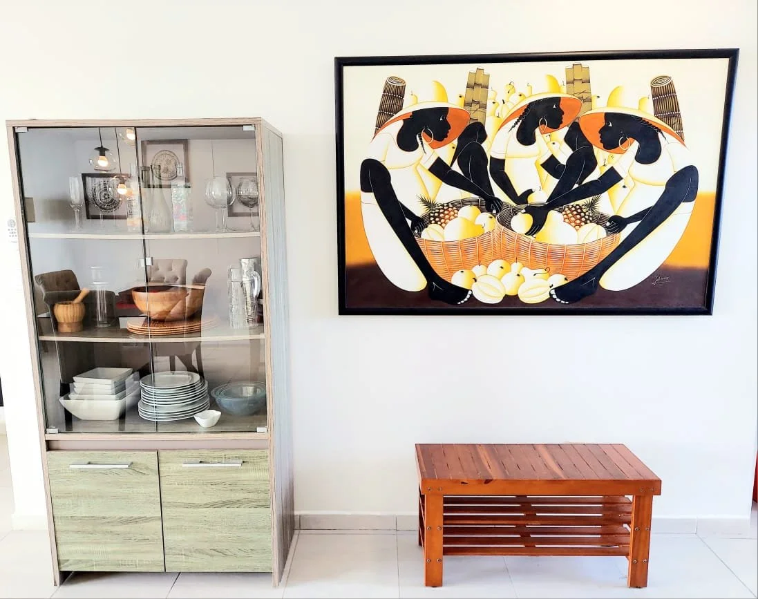 Living area with a cabinet full of dinning dishes. Sitting shoe rack.