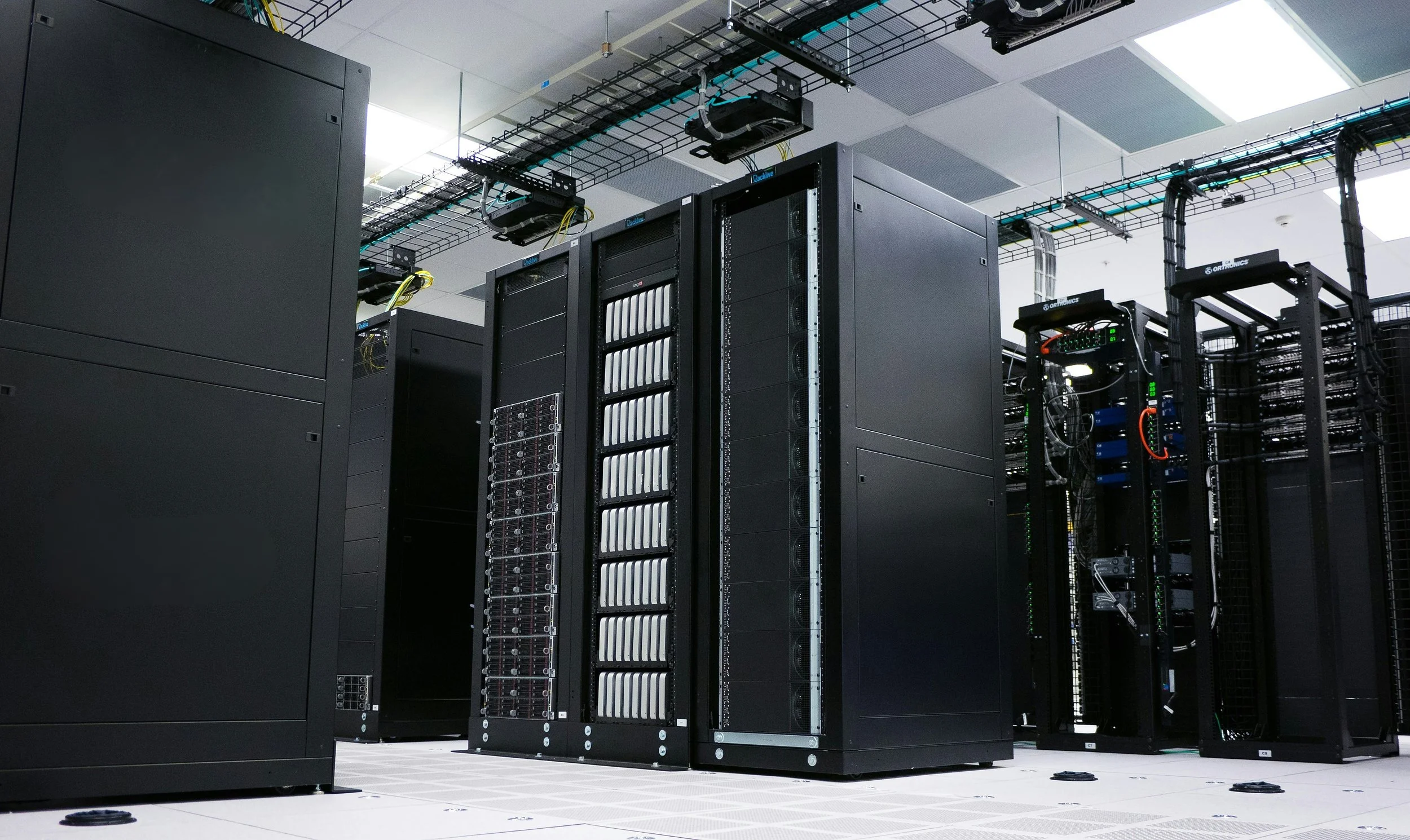 Interior of a data center with rows of servers and network equipment.
