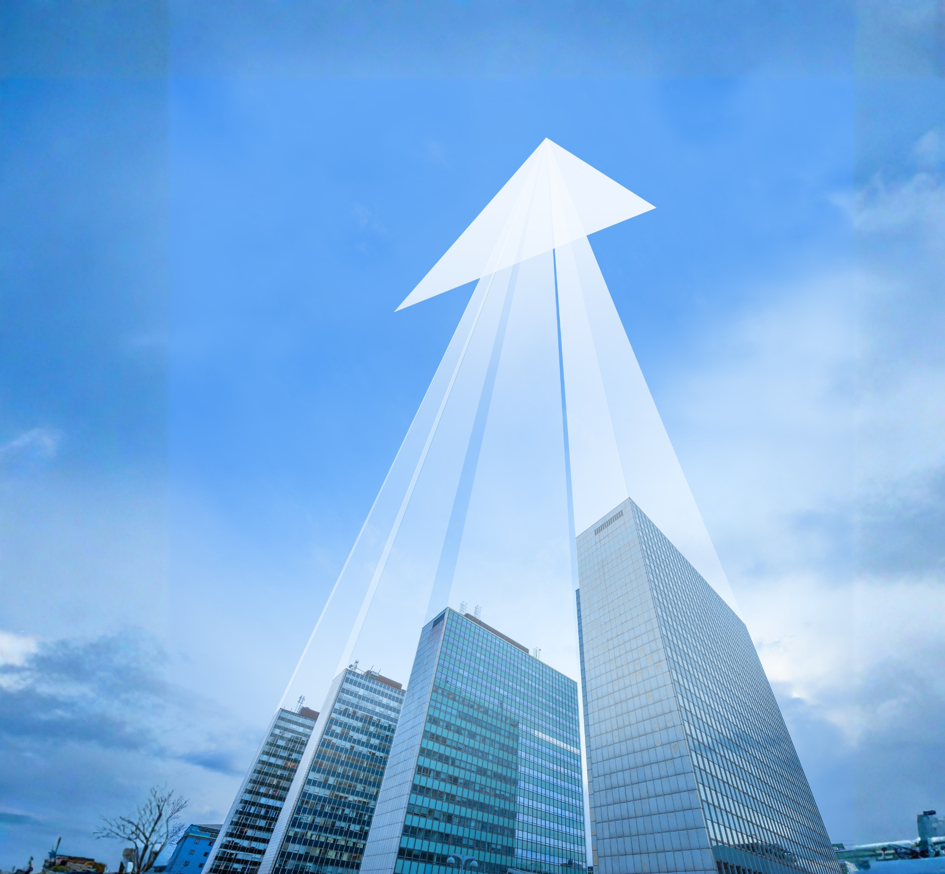View of modern skyscrapers with glass facades under a bright blue sky with some clouds.