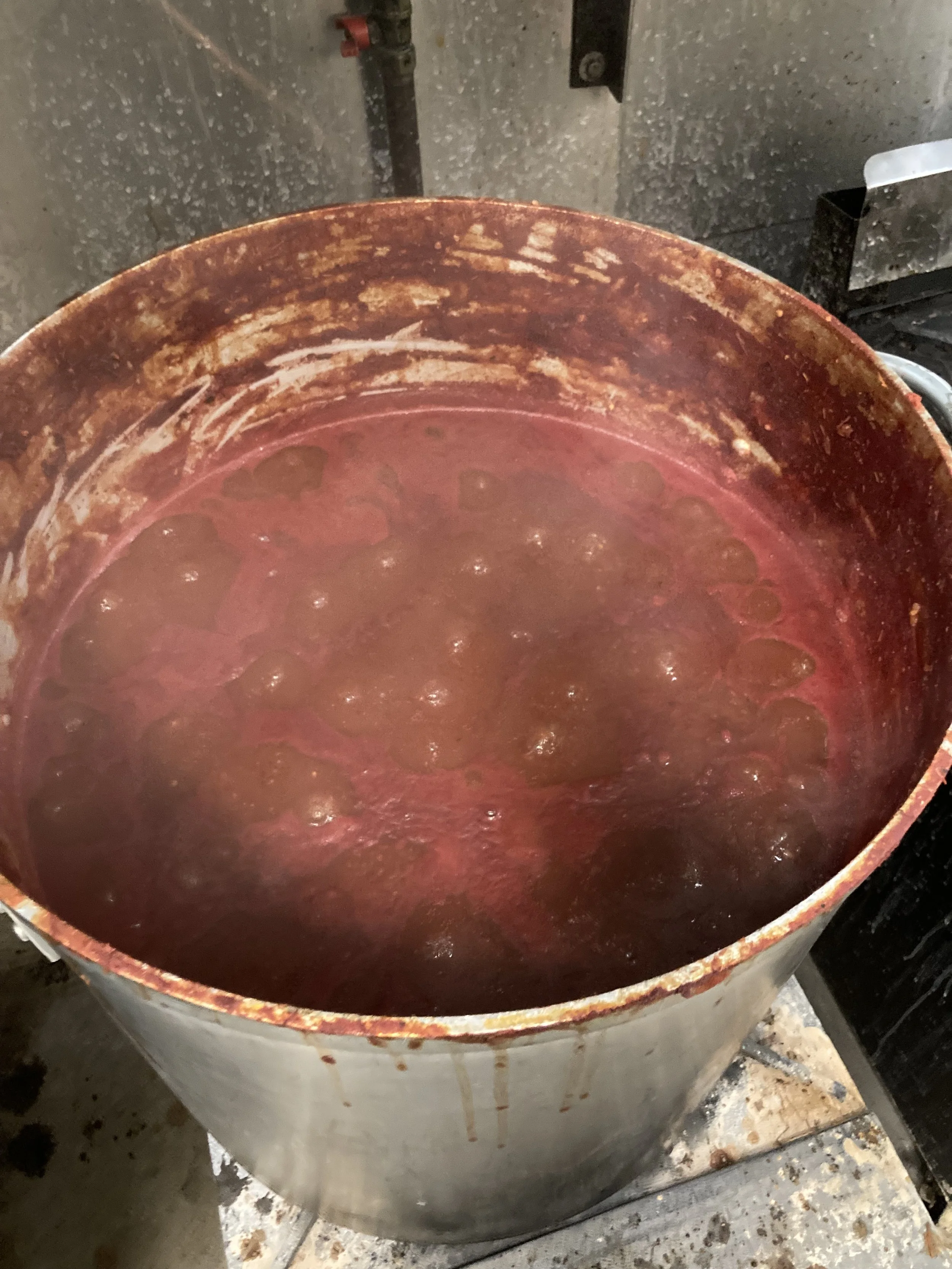 Picture of stockpot full of tomato sauce simmering in kitchen