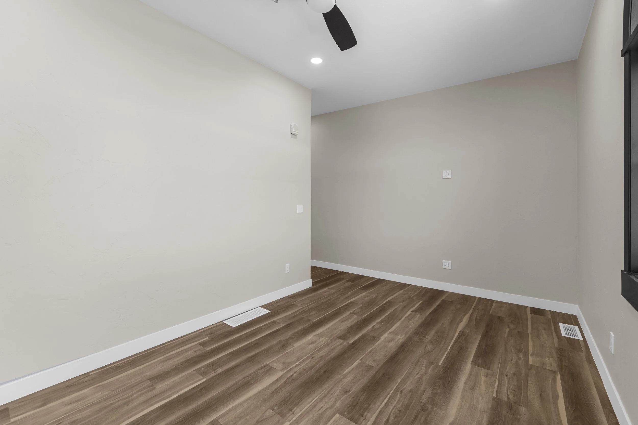 Flexible room inside an Ice Haus Condo for sale in Sheridan, Wyoming featuring hardwood floors, neutral walls, and modern finishes, ideal for bedroom or home office use.