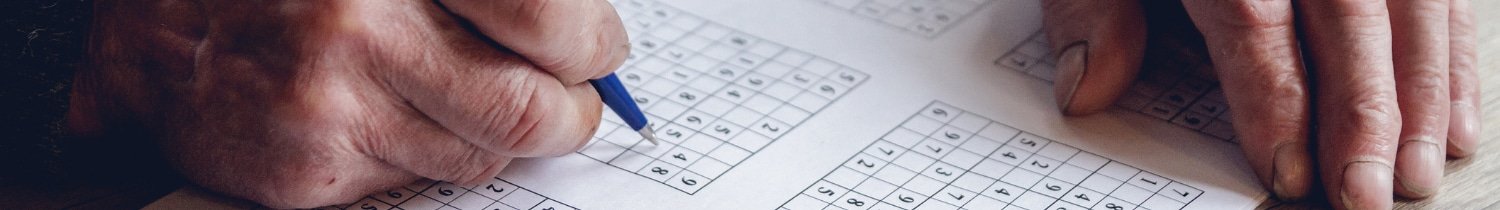 older person doing a crossword puzzle