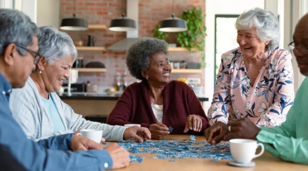 Group of older individuals doing a puzzle together