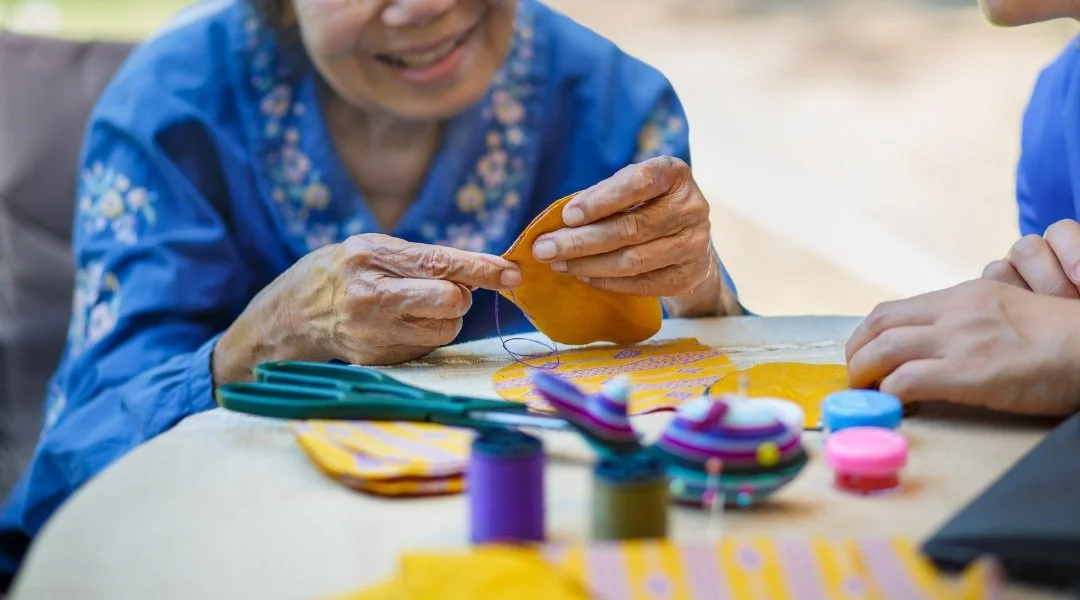 Older woman hand quilting