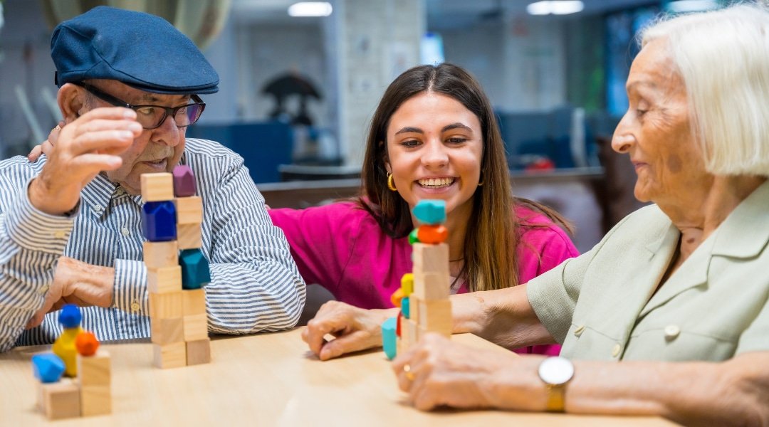 Nurse stacking blocks with older adults in a home setting
