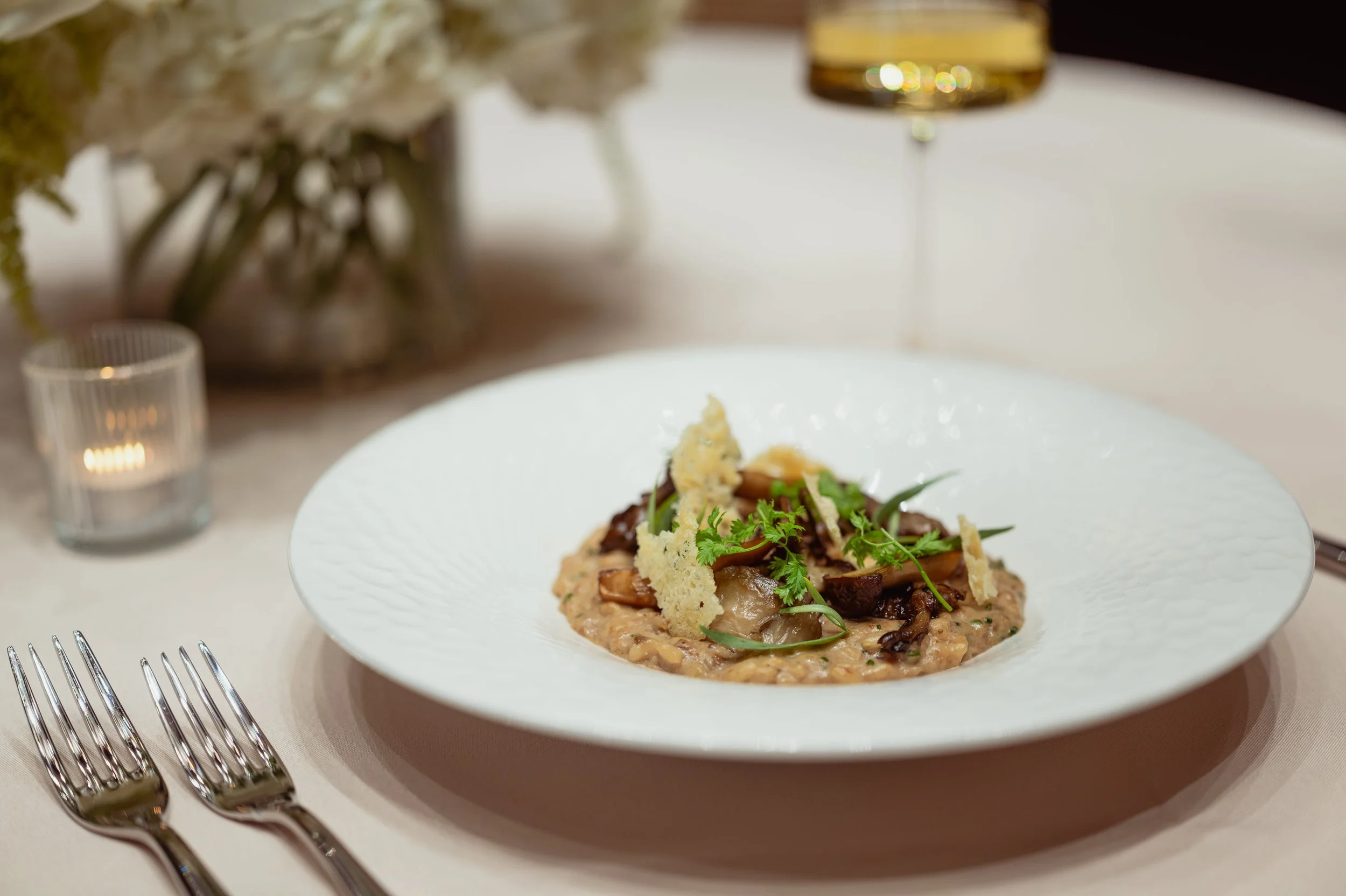 risotto dish on tablescape with wine