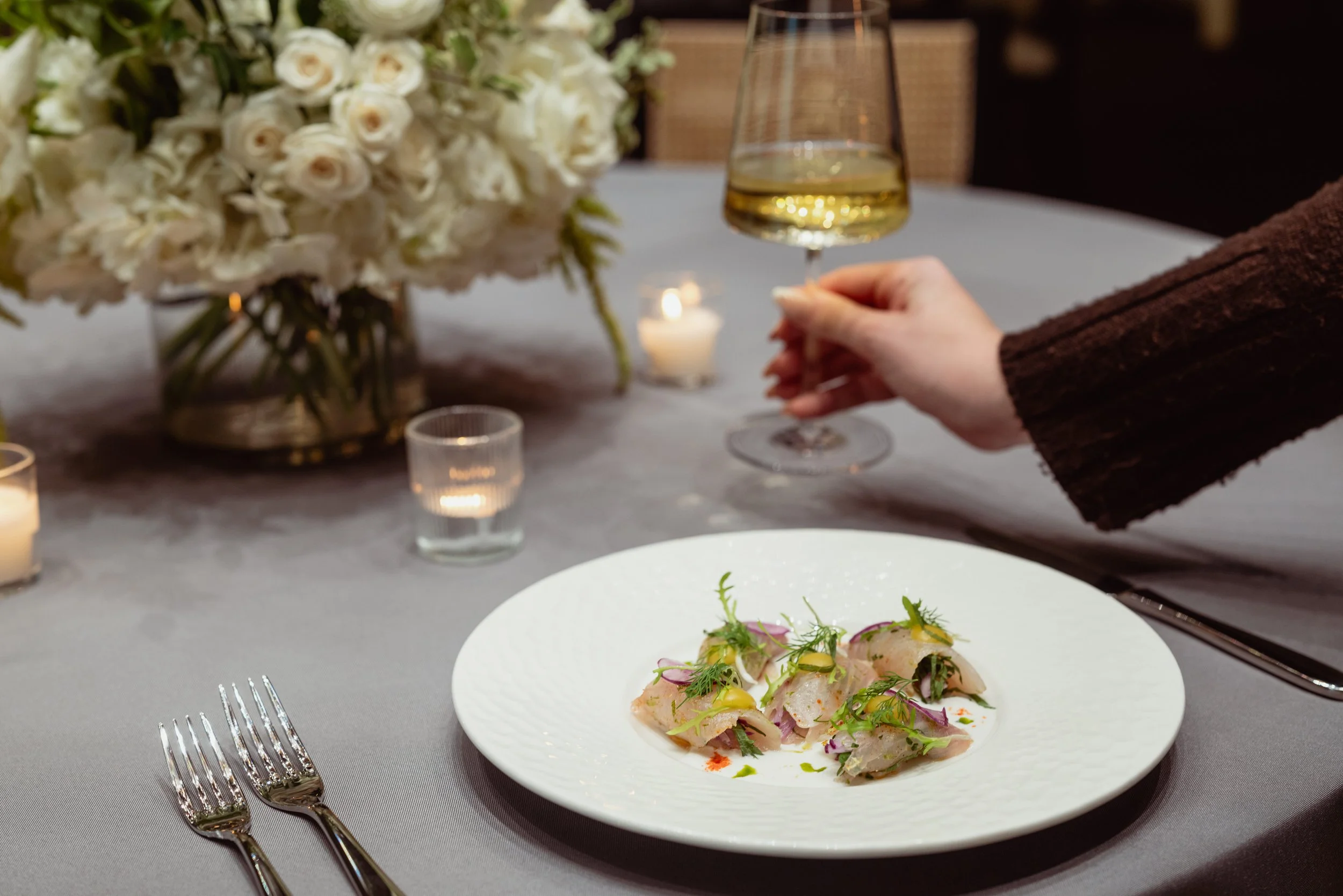 dish dish with wine on table with florals and candles