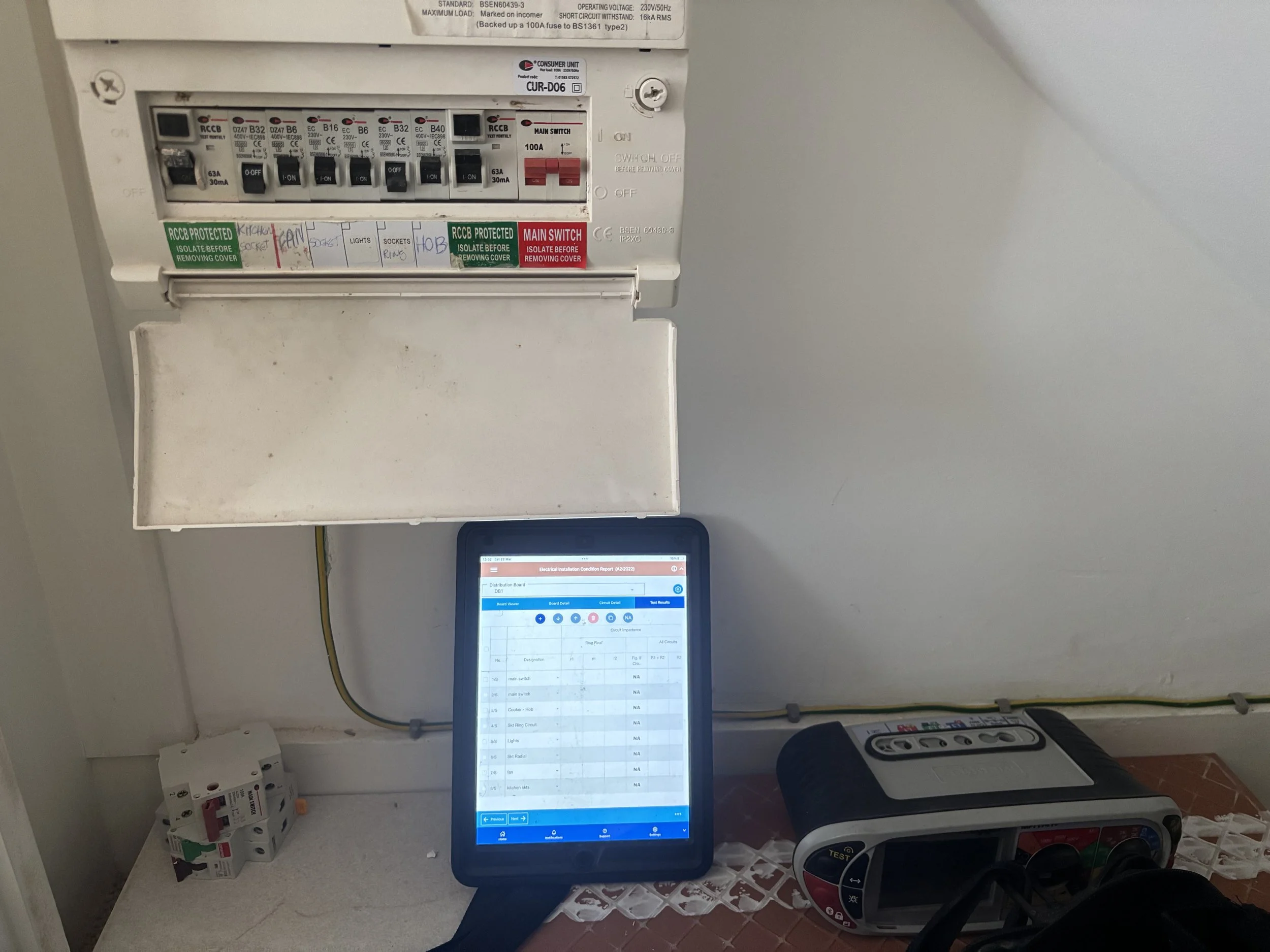 consumer unit being checked by machine plugged into unit