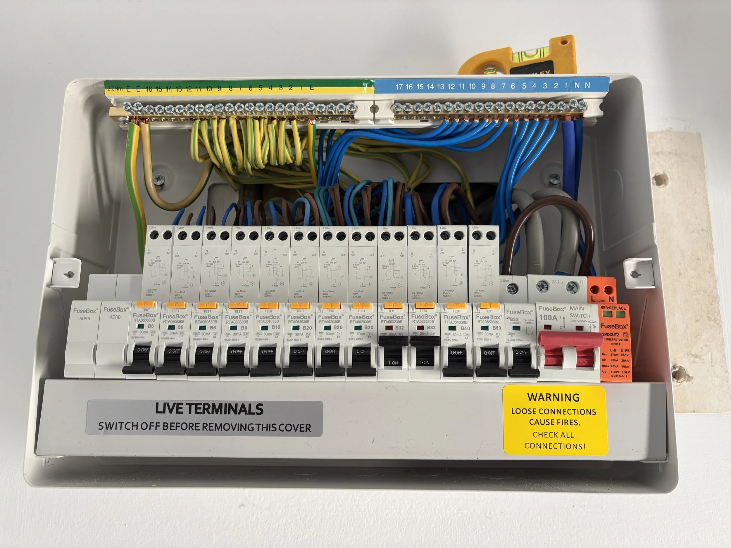 consumer unit with green and yellow and blue and brown wires