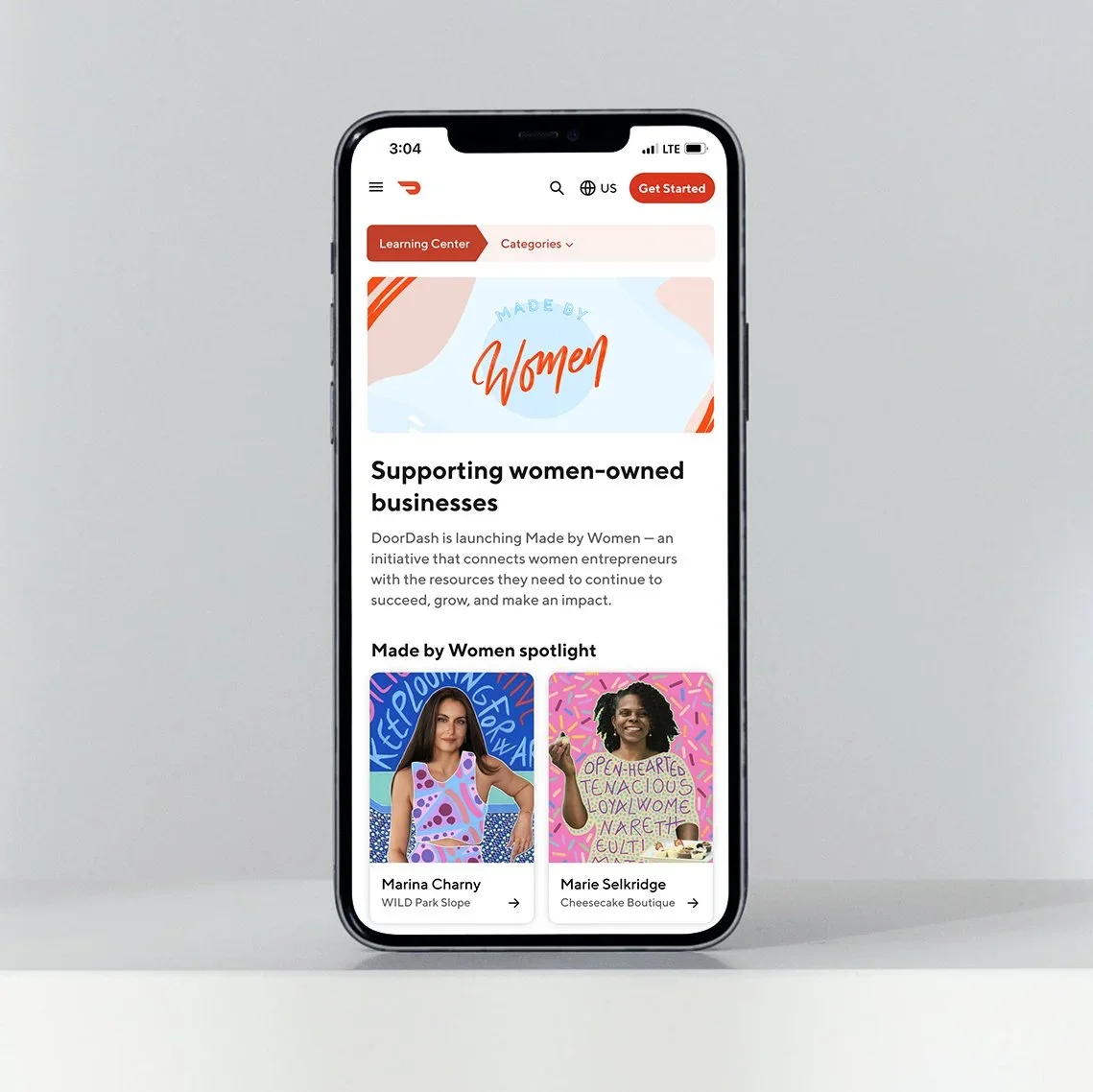Smartphone displaying the DoorDash app with a section titled 'Supporting women-owned businesses,' featuring profiles of women entrepreneurs Marina Charny and Marie Selkridge.