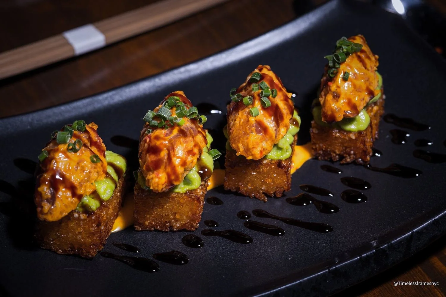 Four pieces of crispy rice topped with spicy tuna and avocado