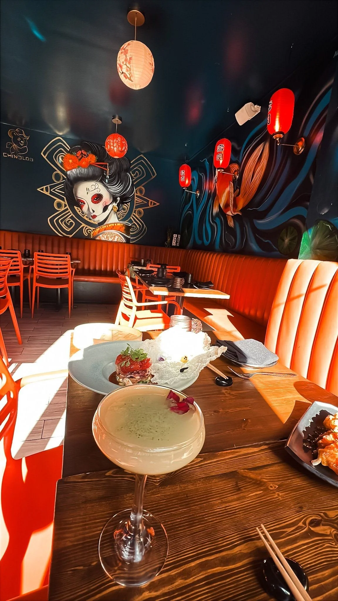 Chinaloa dining room with the geisha mural, red lanterns and orange booths