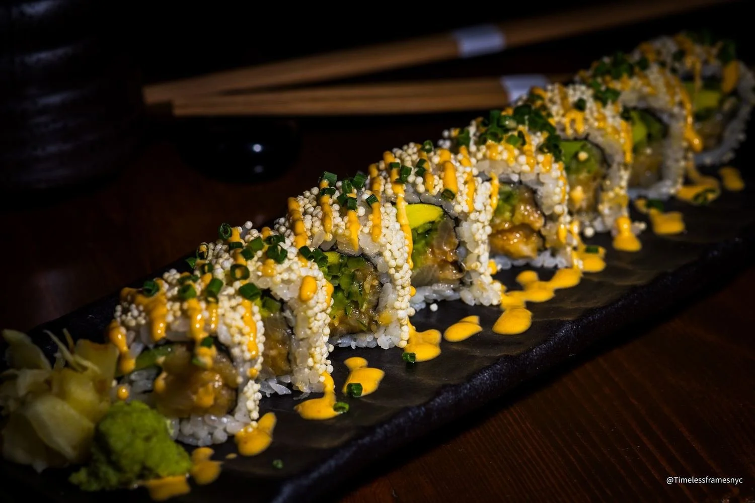 Sushi roll coated in crispy tempura flakes with spicy mayo, pickled ginger and wasabi